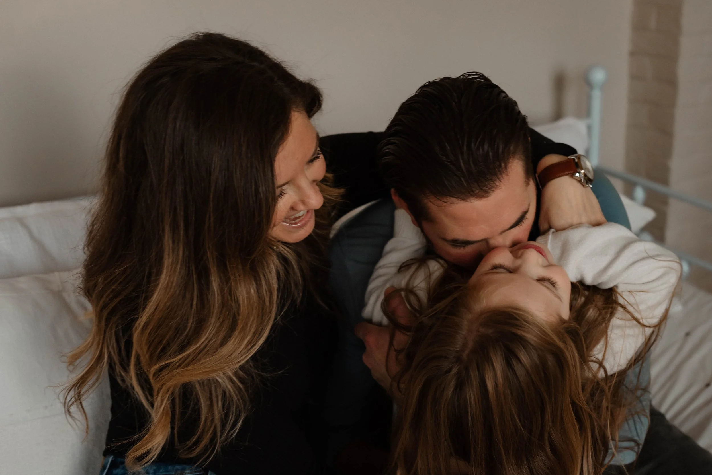 A family gives big hugs during their latest family photos.