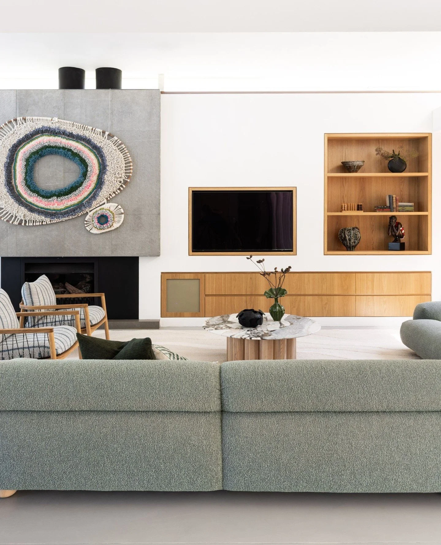 CLONTARF BEACH HOUSE | LIVING⁠
Our client's stunning @tammykanat tapestry took centre stage in the living space and inspired the colour palette of the soft furnishings.  The existing joinery was updated with oak veneer and a large custom rug from @ba