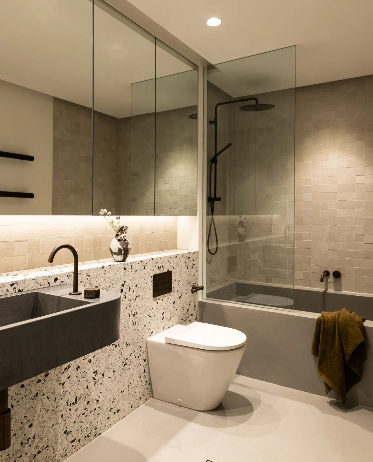 CLONTARF BEACH HOUSE | TEEN BATH⁠
We designed this bathroom for the client's teenage son to enjoy, situated on the lower ground floor with no natural light, we leaned into the moody feel- mixing tones of grey with a custom concrete basin, micro cemen