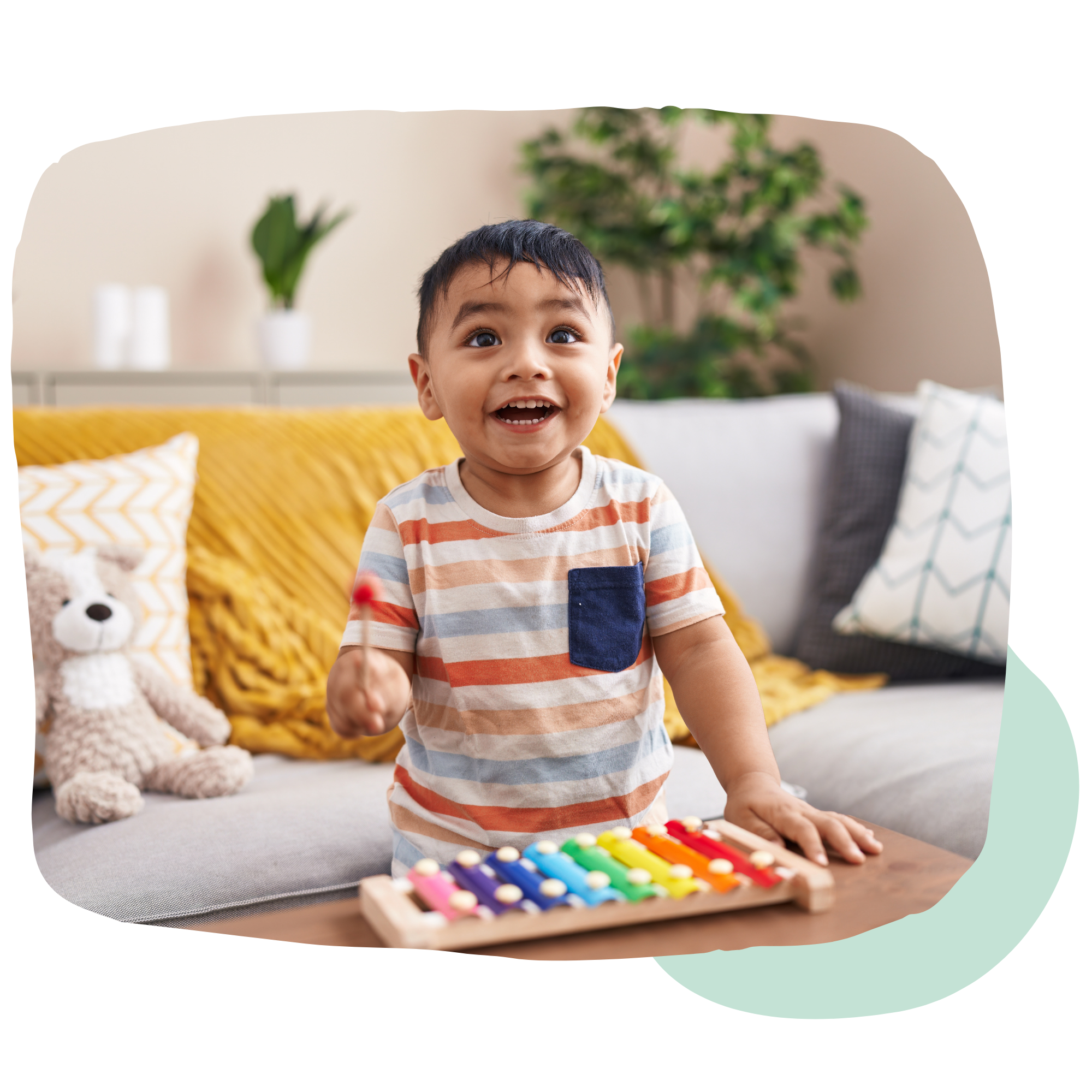 happy child playing with colorful xylophone