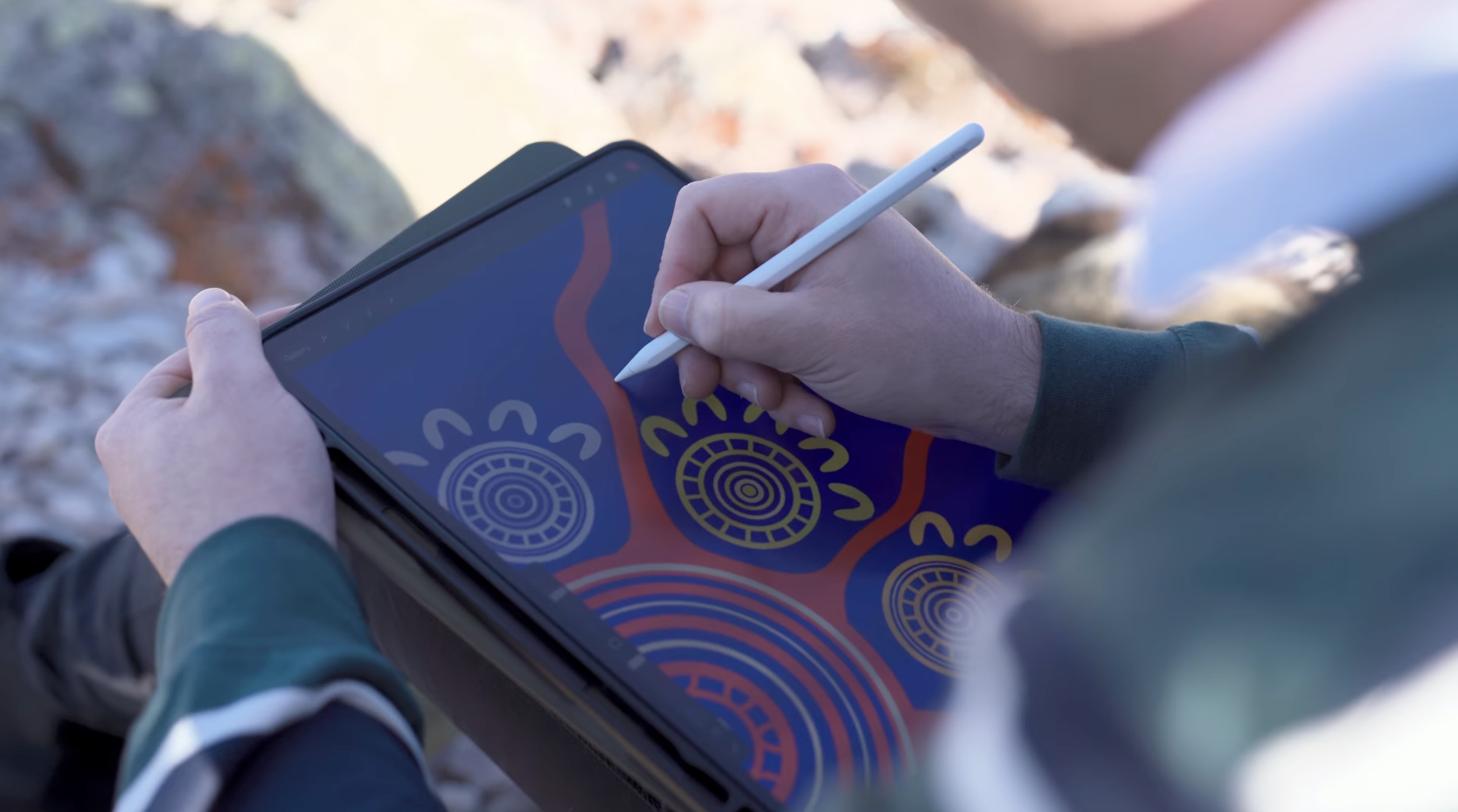 Close-up of Caleb Nichols-Mansell working on Pathways to Support on an iPad with a stylus.