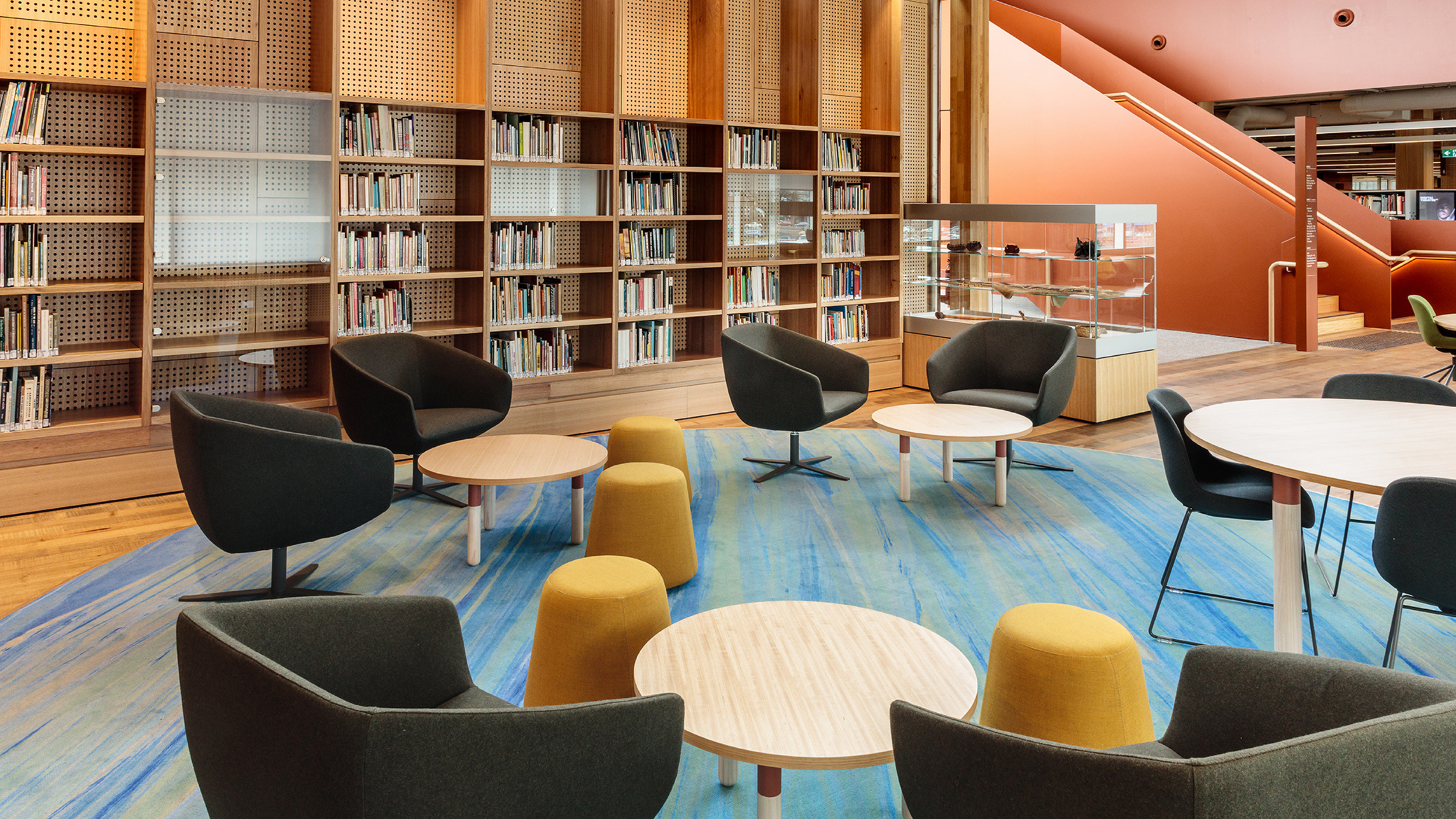 Muka’s blue and sand-coloured carpet beneath lounge seating in the Riawunna Collection area at UTAS Inveresk Library.