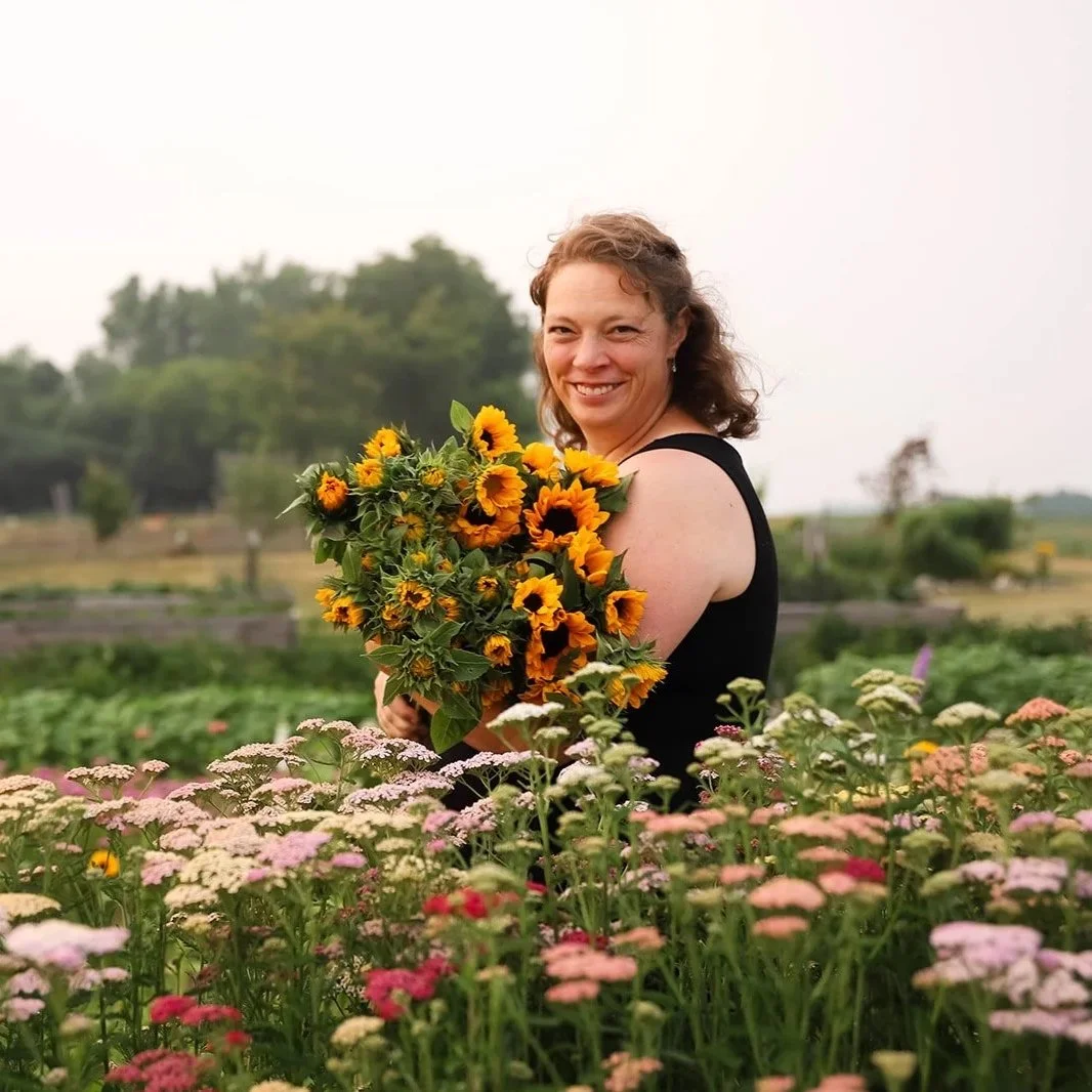 Flower Farm Michigan - woman holding a bouquet of sunflowers