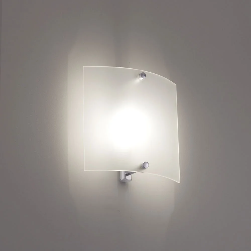 curved square glass sconce illuminated on a wall