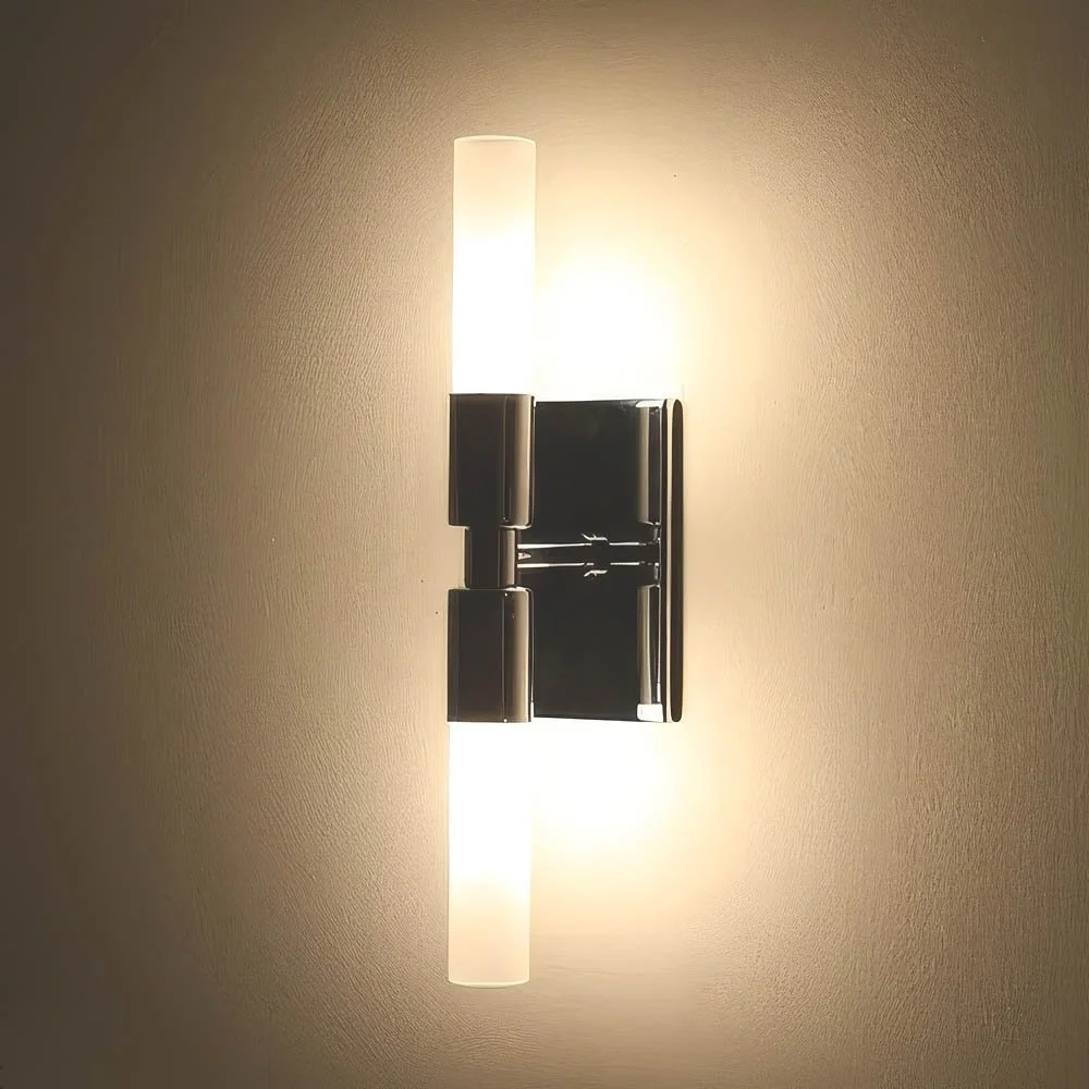 slender cylindrical glass luminaries illuminated as a single wall sconce