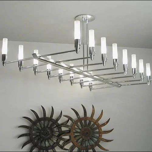 polished chrome modern linear chandelier with glass luminaries on stems projecting on either side of a long central extrusion