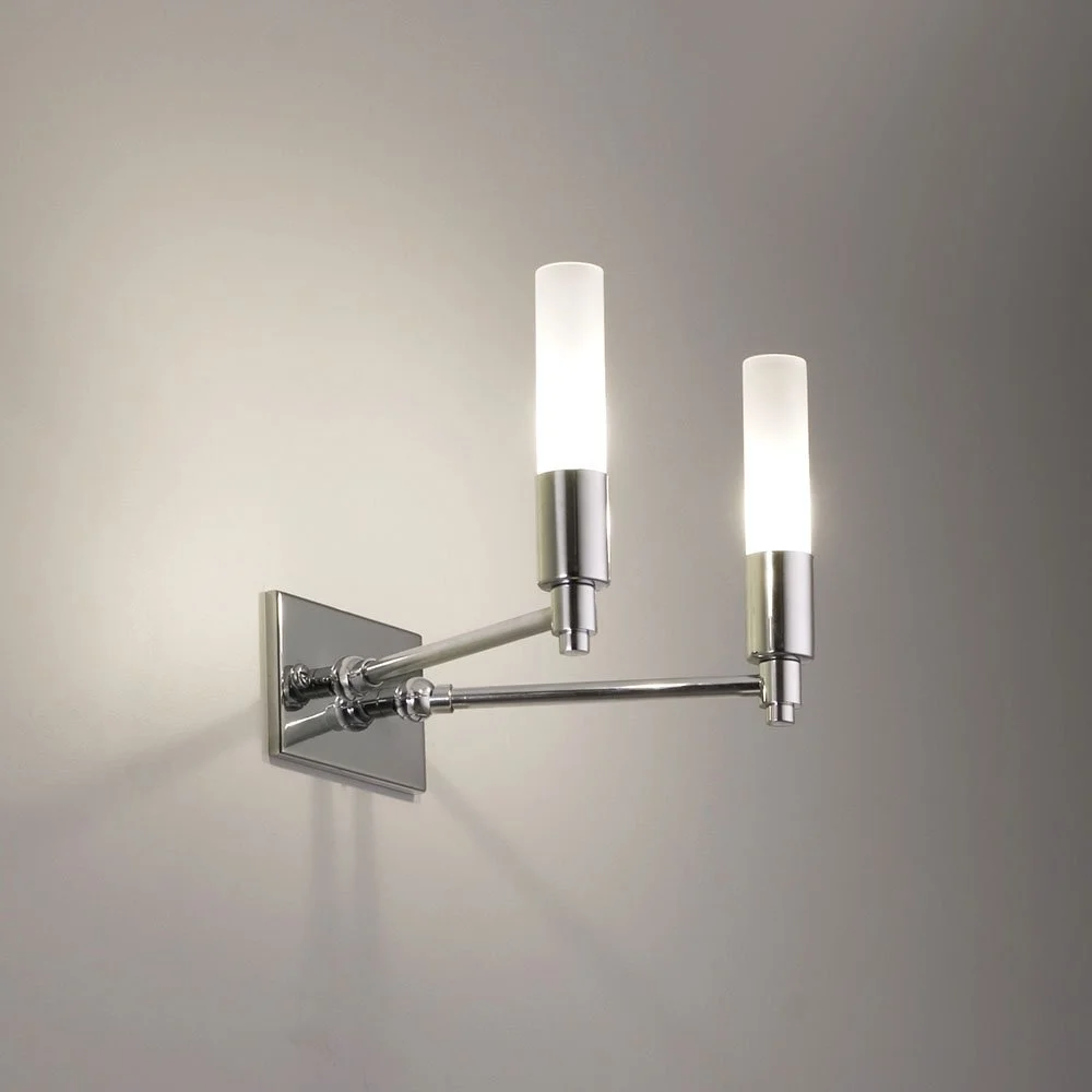 double cylindrical glass sconce with two arms coming out of a mounting plate