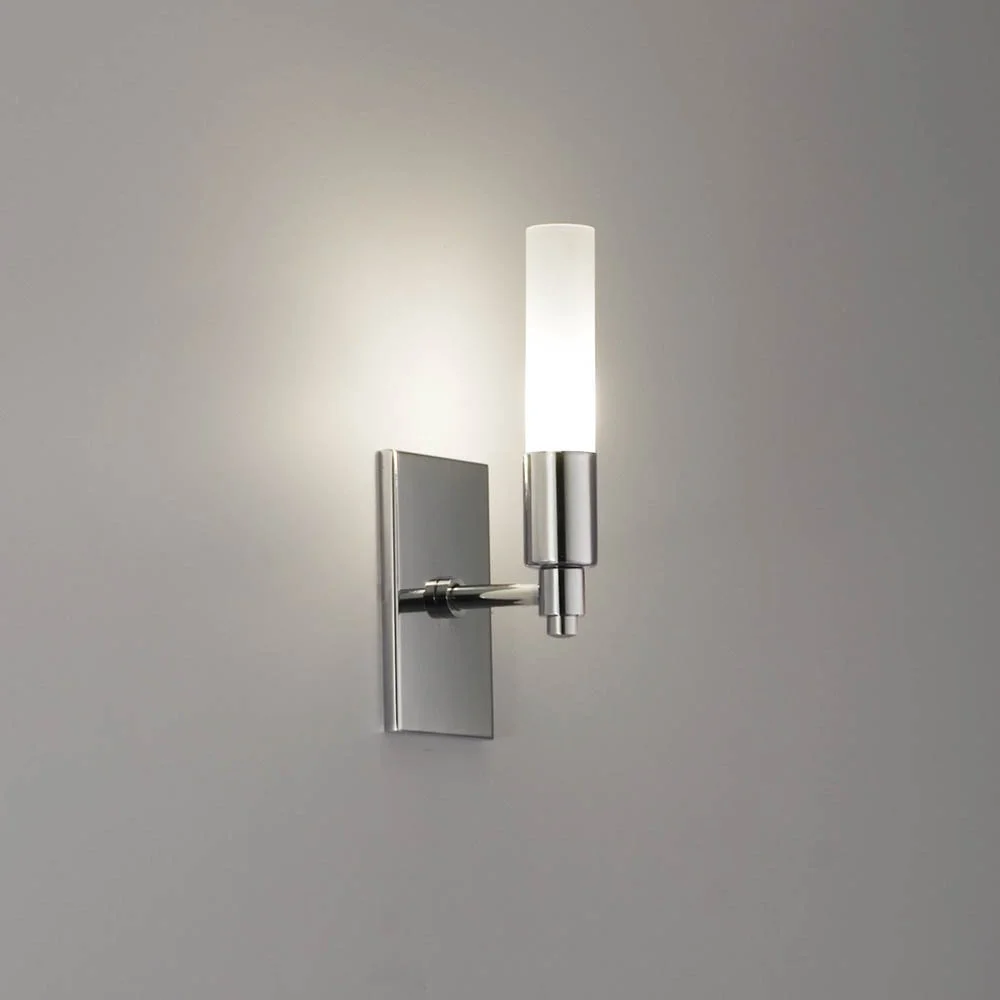 slender cylindrical illuminated glass luminary with a polished chrome body with a short stem projecting from the center of a vertical rectangular mounting plate