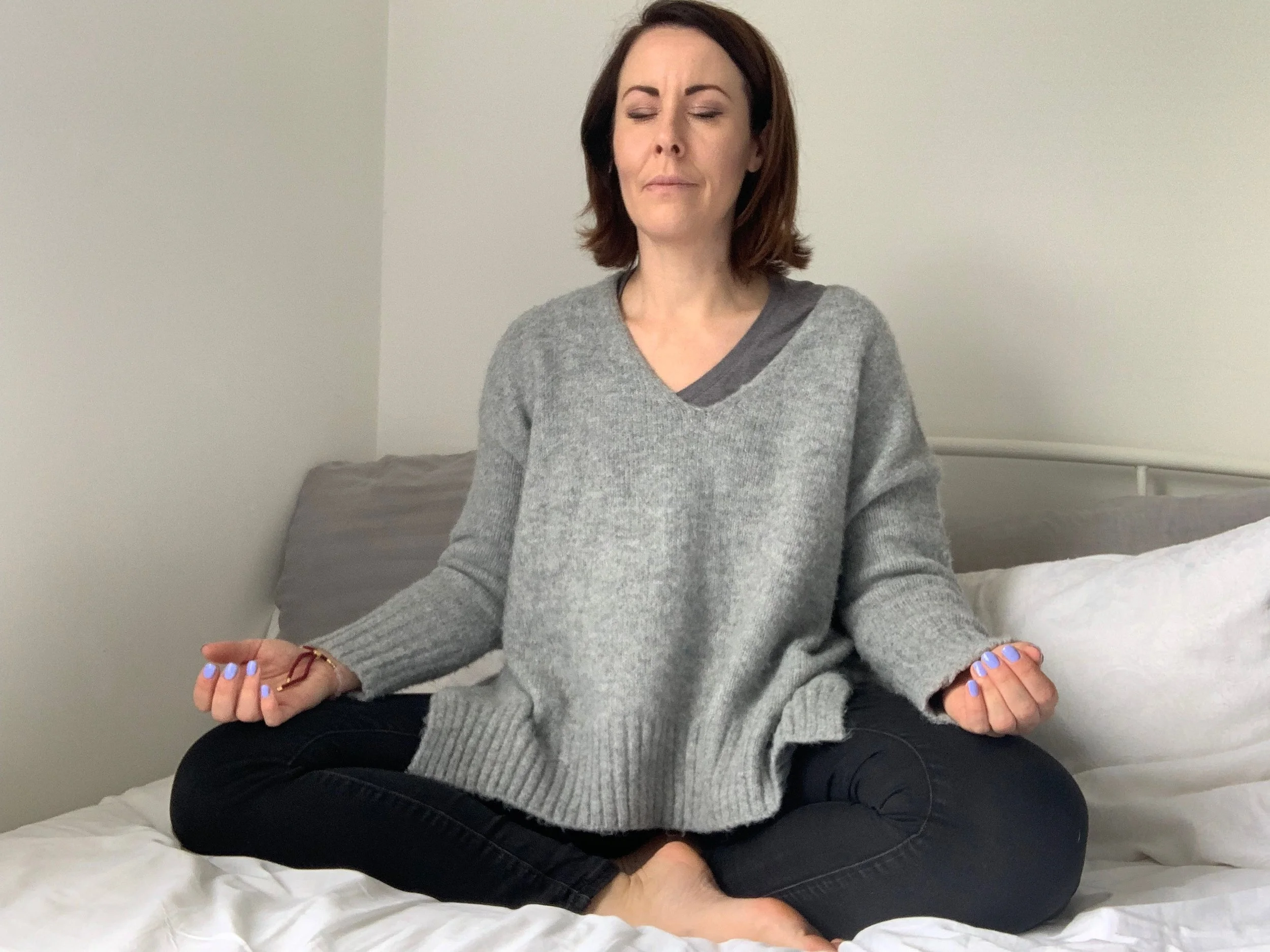 Me meditating on my bed