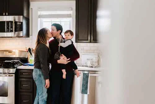 familly-of-three-in-kitchen-kissing-ridgewood-nj.jpg