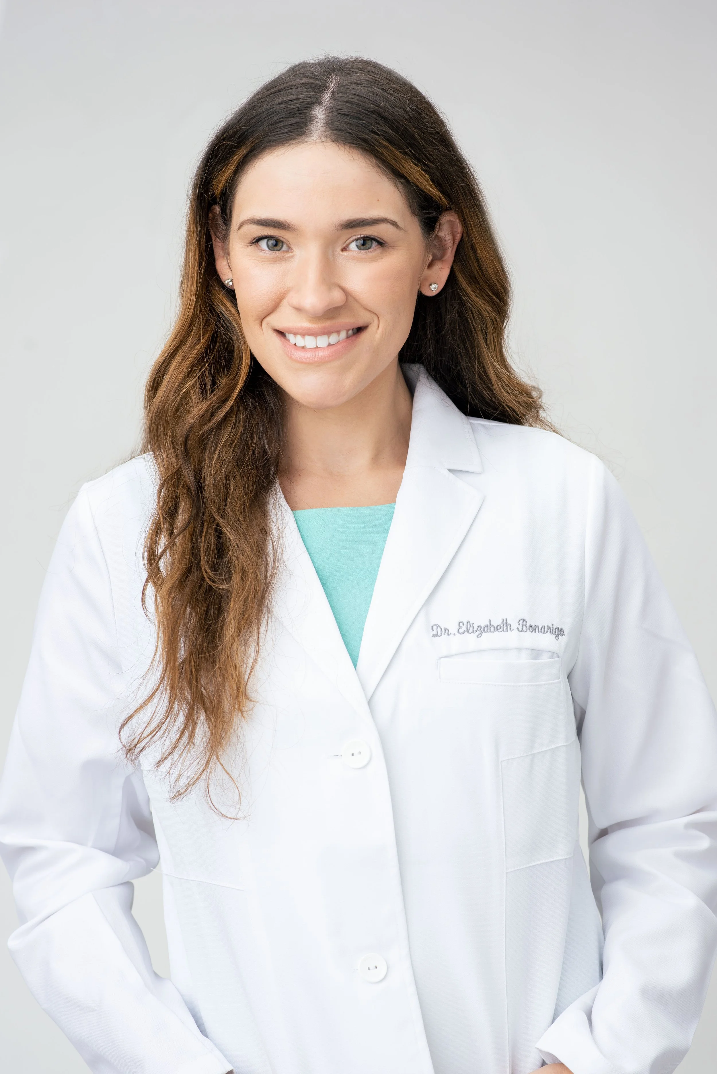 Female doctor in a white coat smiling