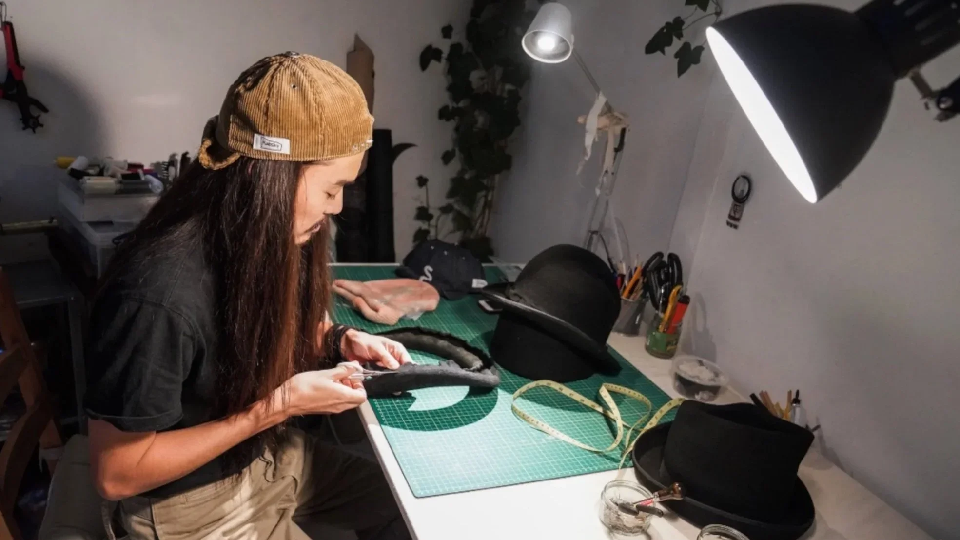 Makoto Kushida at work inside the Makshy London studio — shaping and stitching hats by hand using traditional millinery techniques that define the brand’s refined, handcrafted aesthetic.