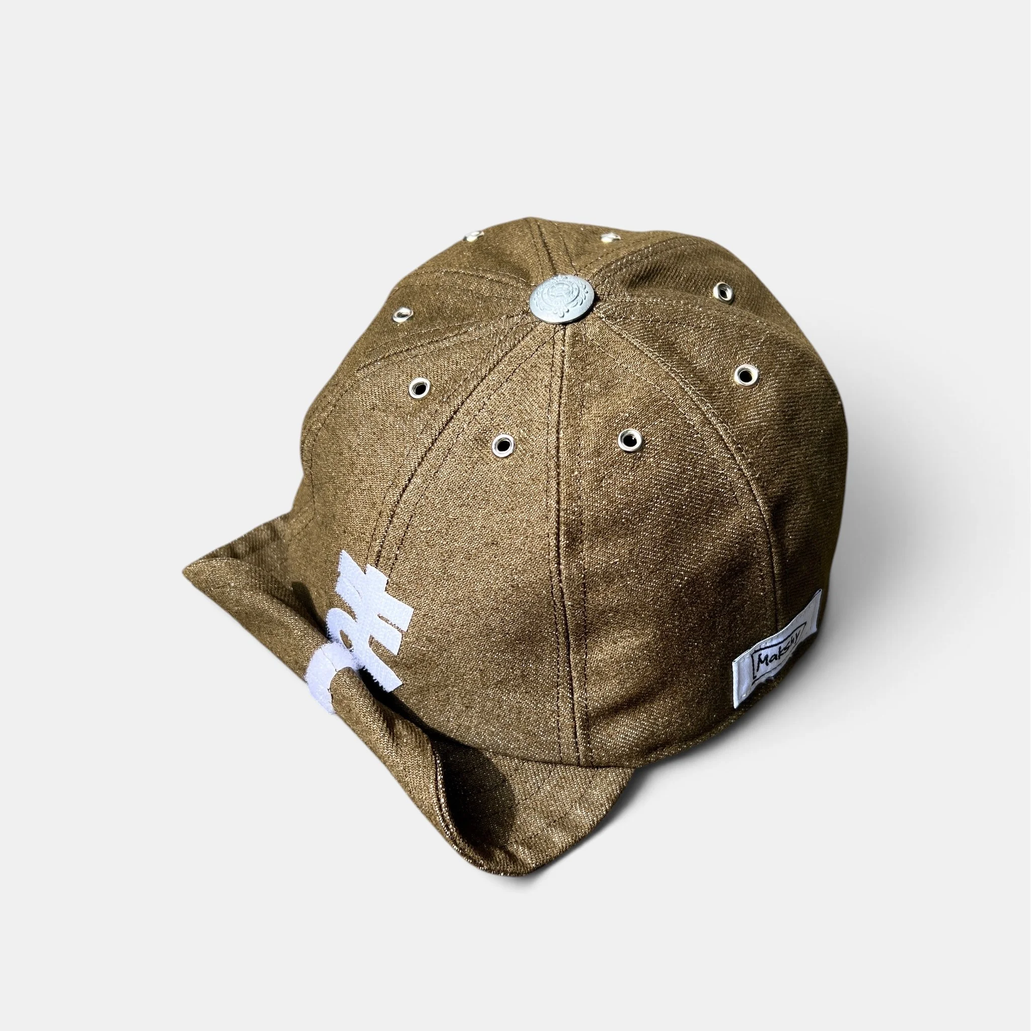 Three-quarter view of olive-brown cotton denim cap with personalised white motif and roll-up visor