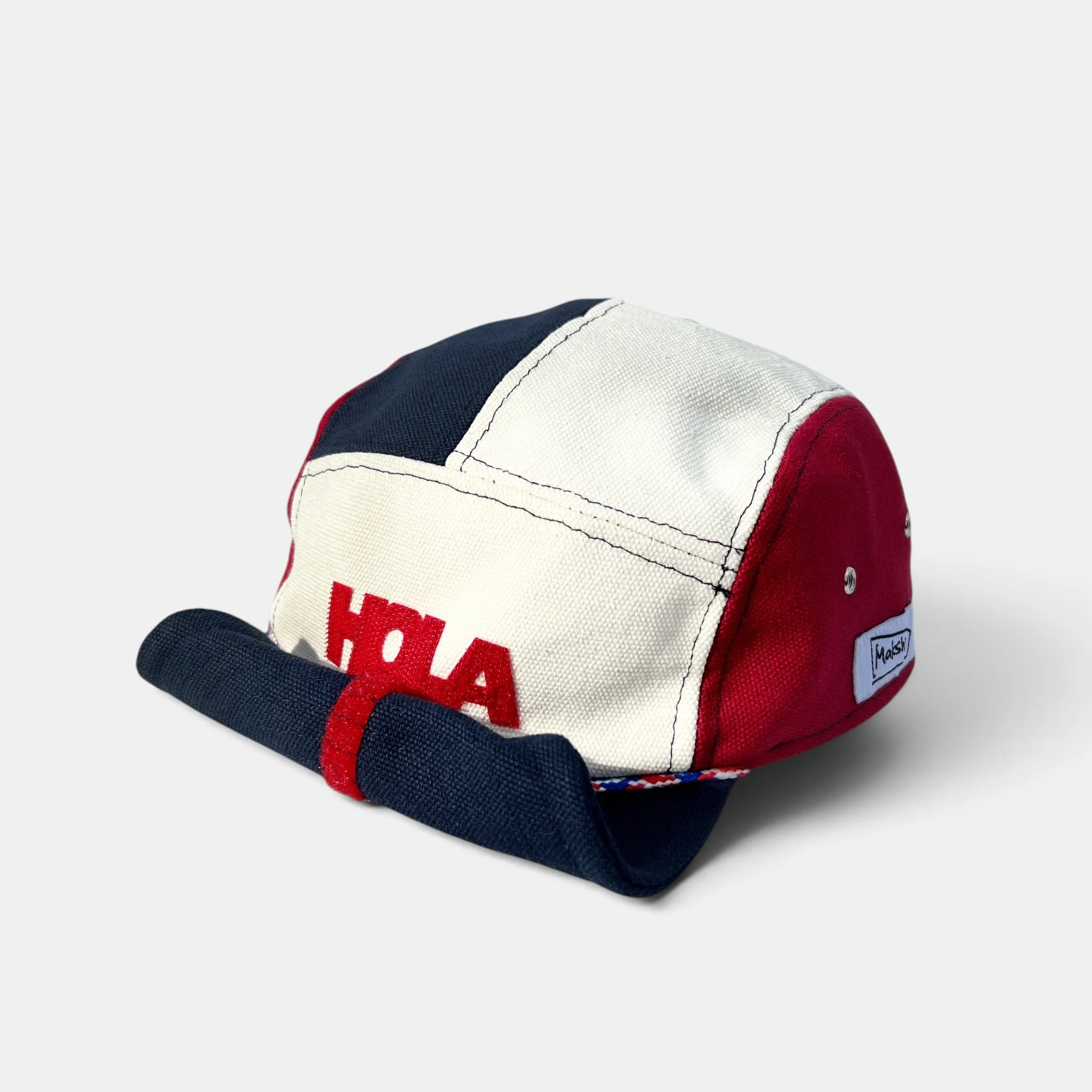 Red, navy and off-white five-panel canvas cap with HOLA motif, coordinating rope trim and rolled-up visor.