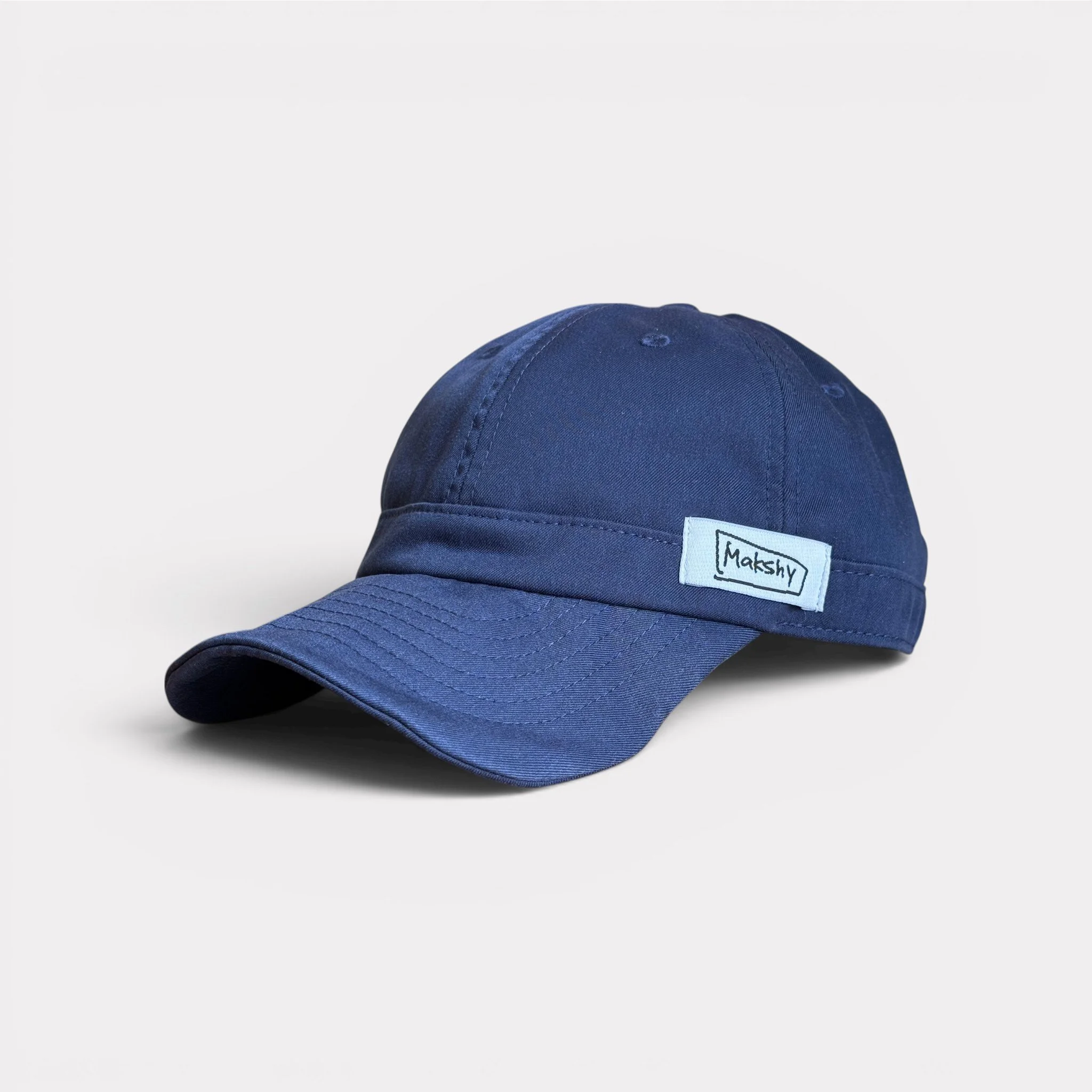 Navy six-panel baseball cap in Japanese technical fabric with shapeable wired visor and foldable design.