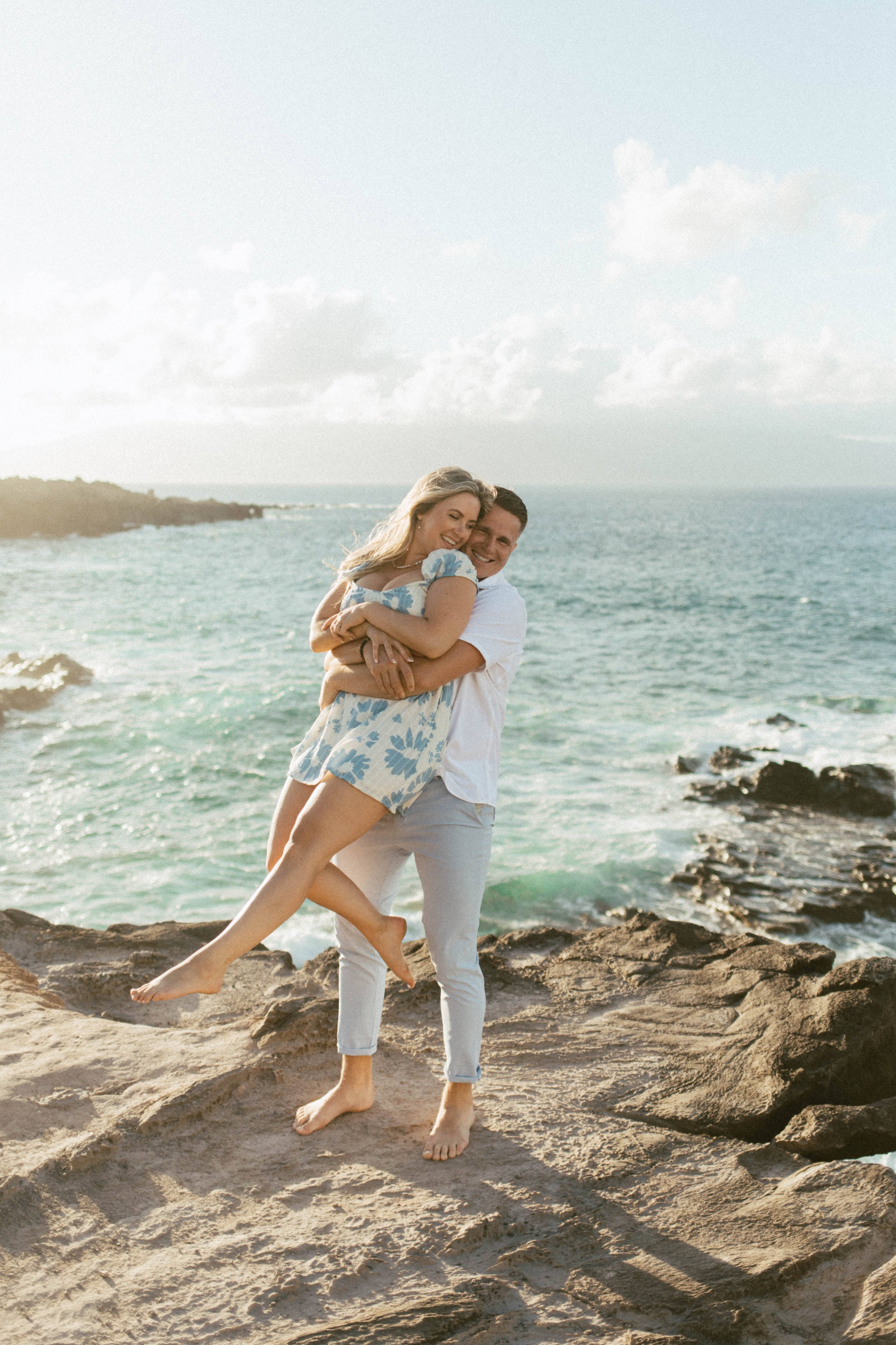  A couple doing the hug from behind lift pose  for their engagement session, one the common couples photoshoot poses 