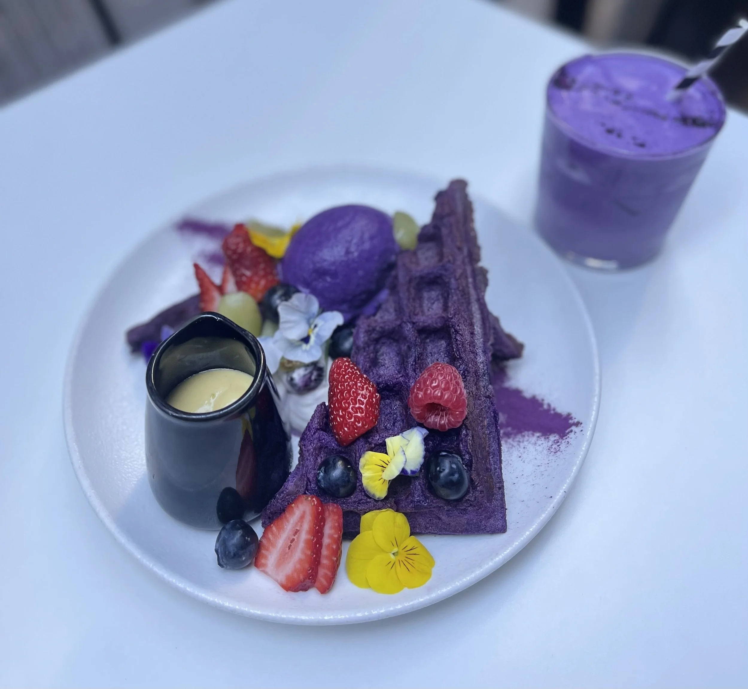ube waffle with fresh berries, coconut mango sauce and house made ube ice cream 