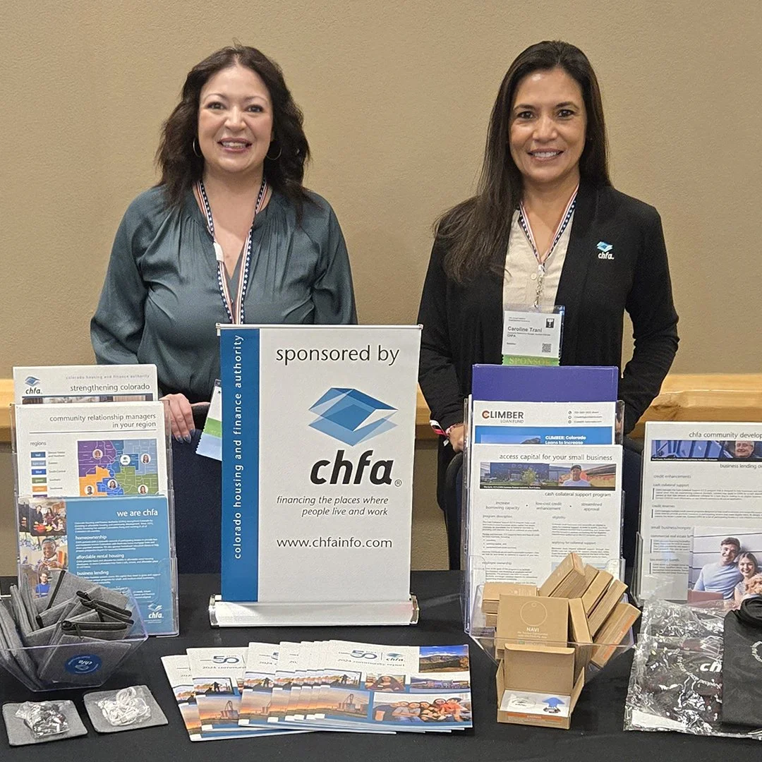 Kaylee Romero and Caroline Trani, CHFA Community Relationship Managers, at CHFA booth during the Veterans Small Business Conference held in Colorado Springs.