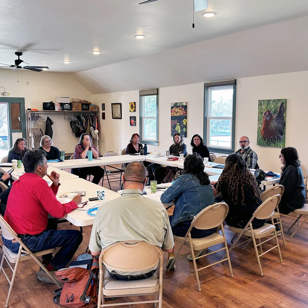 Image of group meeting around a table
