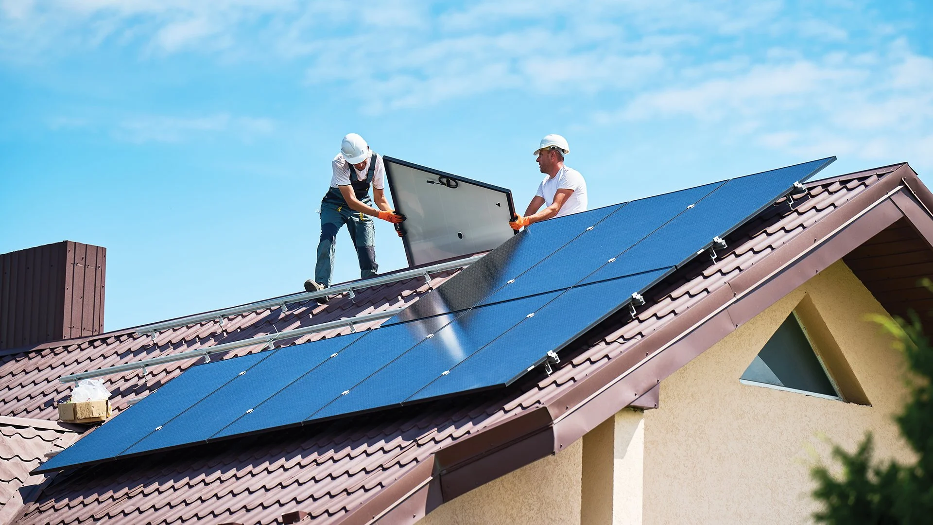 Image of workmen installing solar panels on rooftop