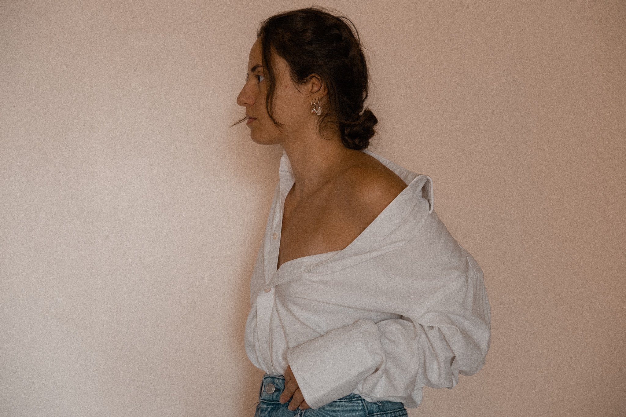 Woman in white shirt, side profile, looking left