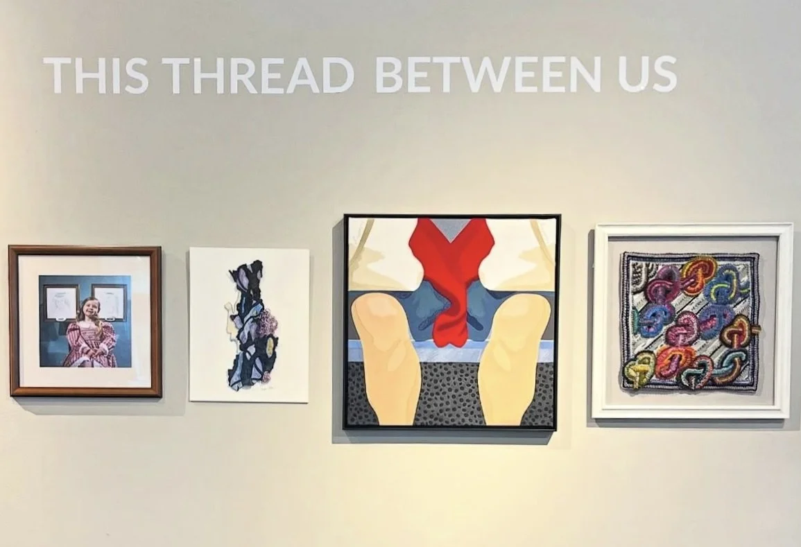 A man struggles to carry a large flower basket on his back, aided by a woman.