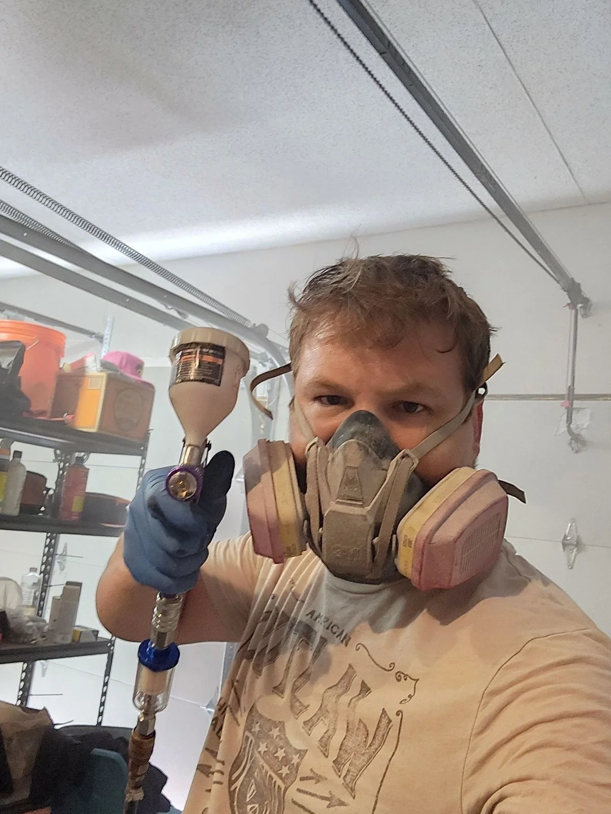 a man wearing a mask while working with a power tool