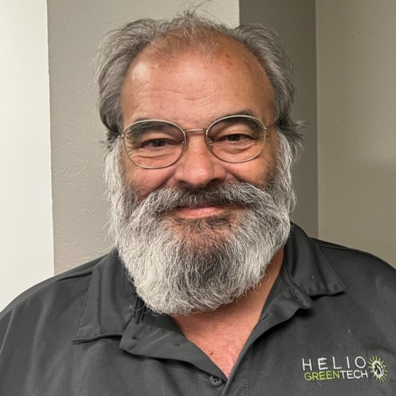 Logo for Helio Greentech featuring the company name in blue and green text, with a sun and leaf design.