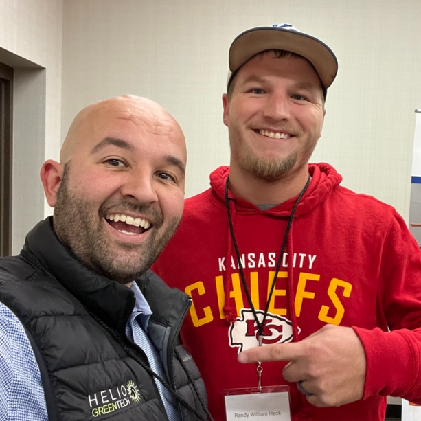 Logo for Helio Greentech featuring a stylized hare head within a sunburst design.