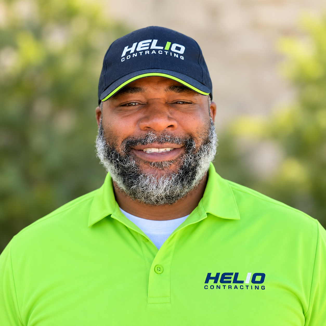 Alti Taylor wearing a green Helio shirt and navy Helio hat.