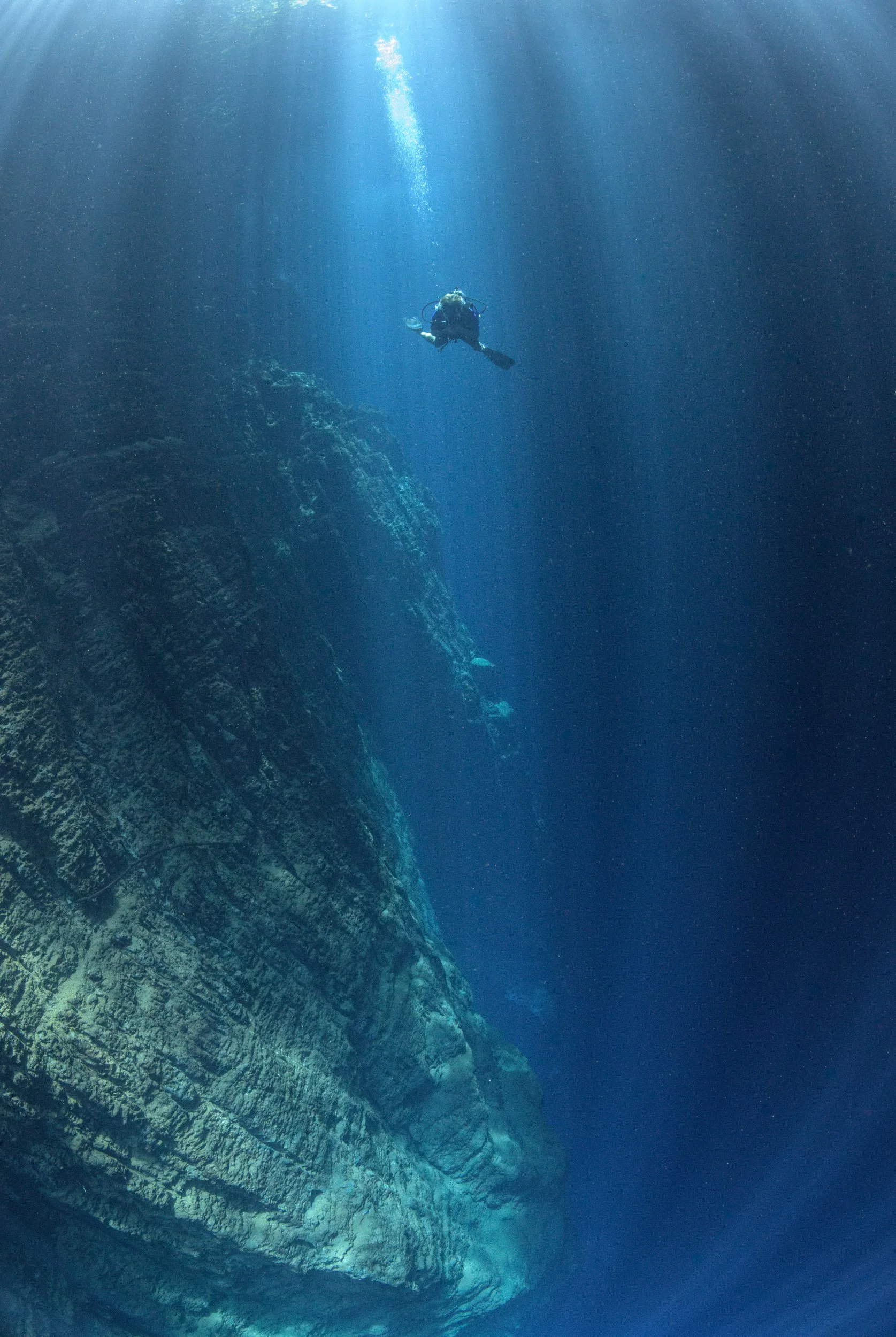 A diver explores the crystal-clear Blue Hole at the source of the Esis River in Pomio District, East New Britain, Papua New Guinea.