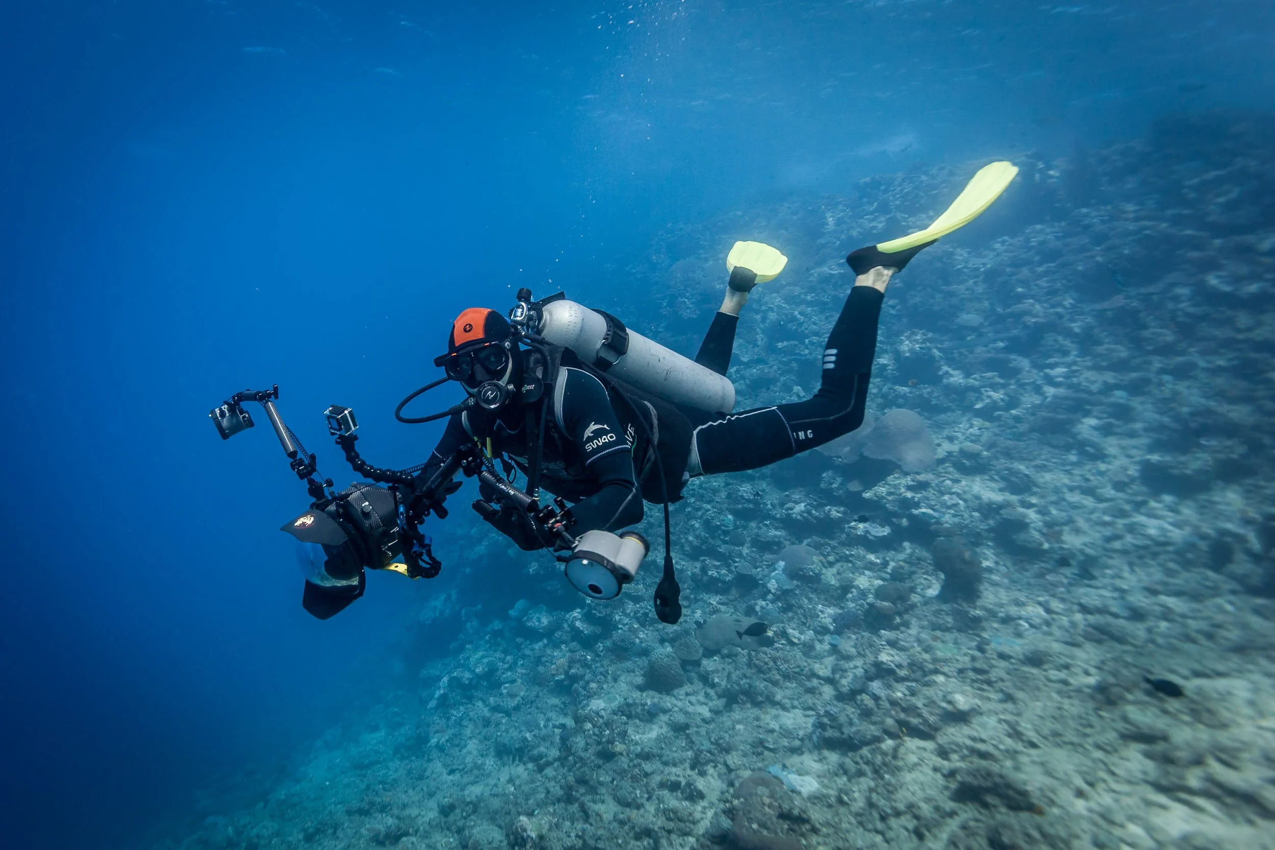 Underwater photographer Tom Vierus diving with his camera at Shark Reef Marine Reserve, Fiji.