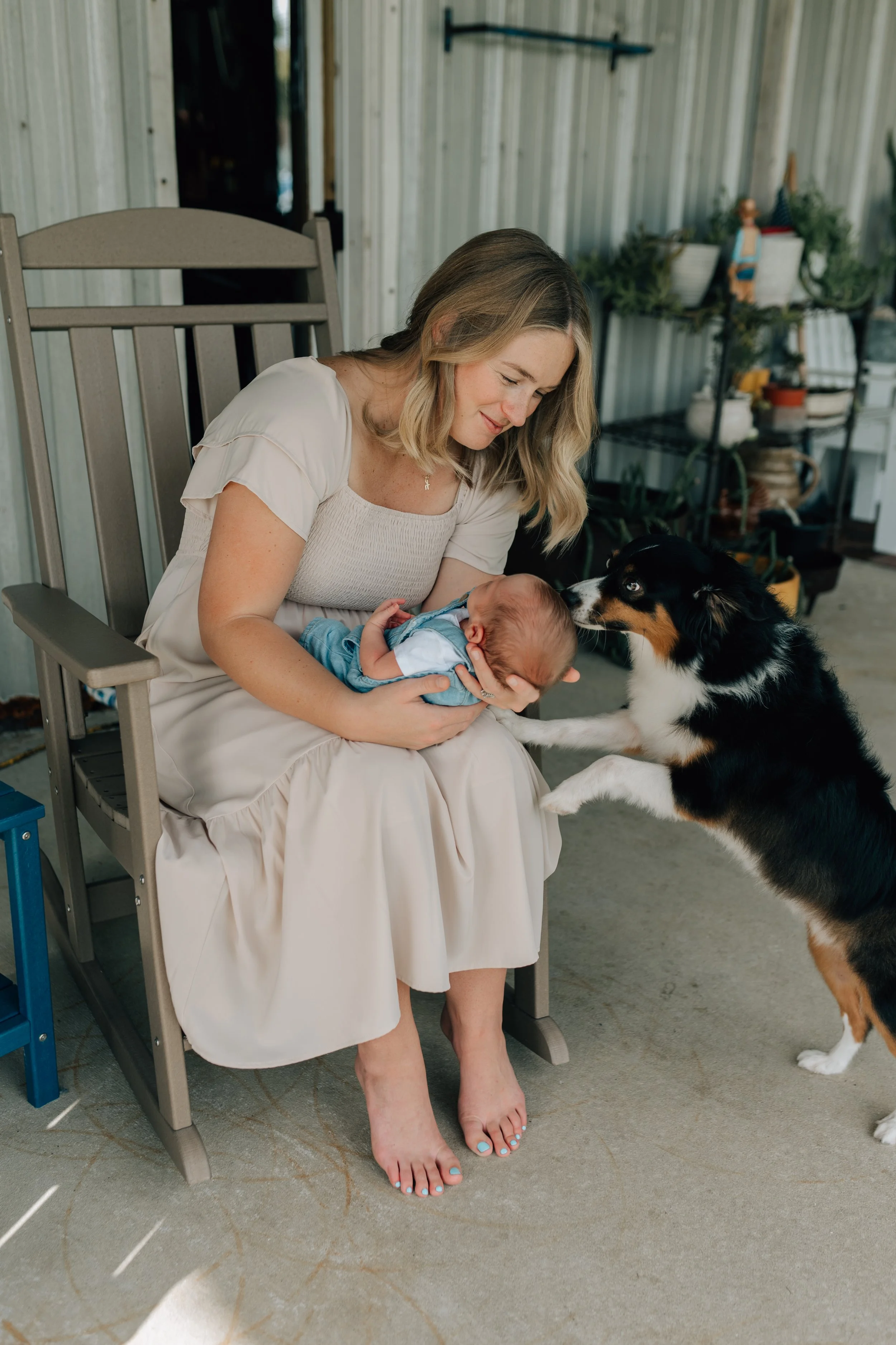 a new mom and her newborn on the porch with their family dog in fellsmere florida