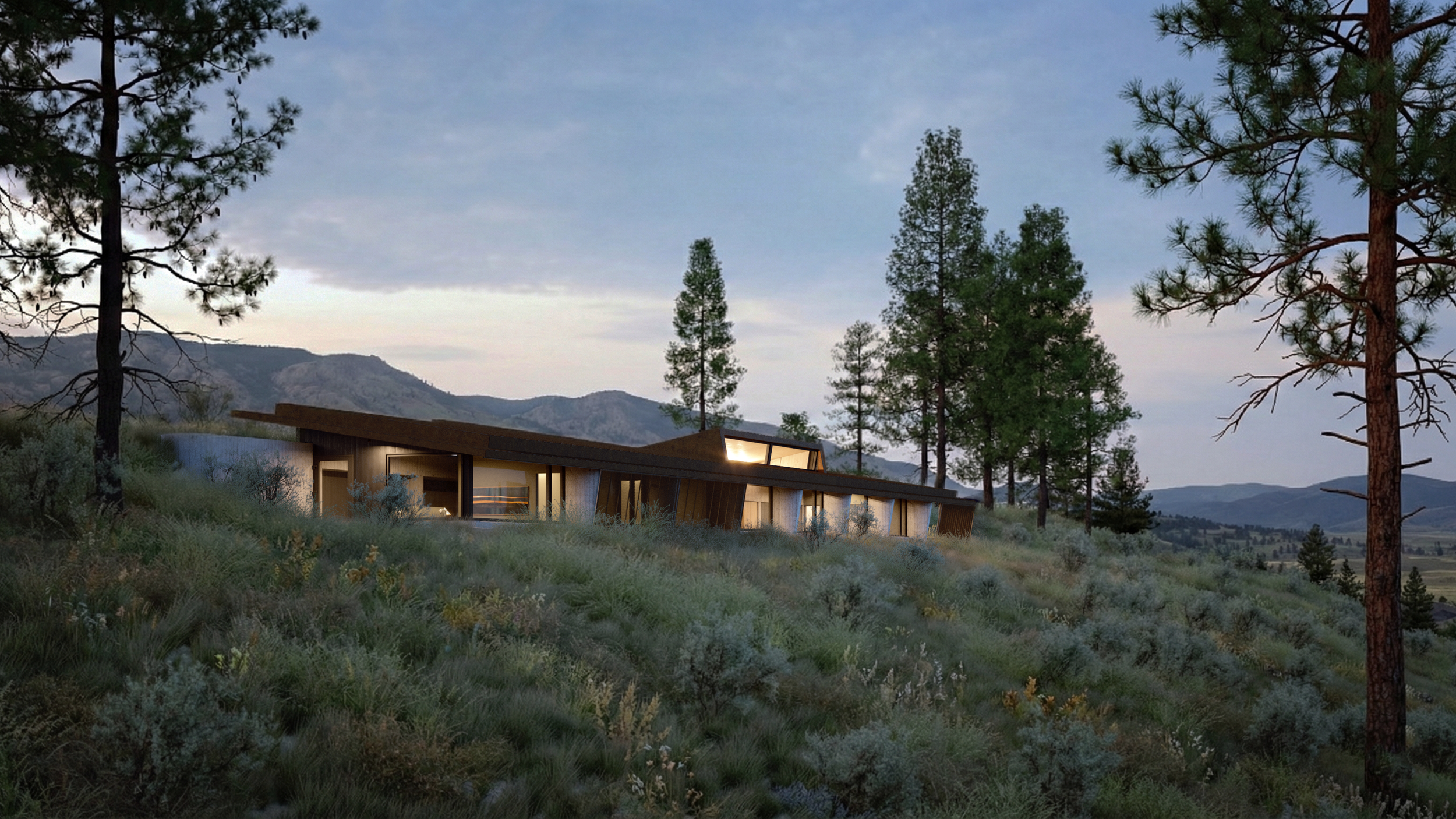 Low house stretched along a wooded hillside at dusk, with warm interior light visible through broad glazing.