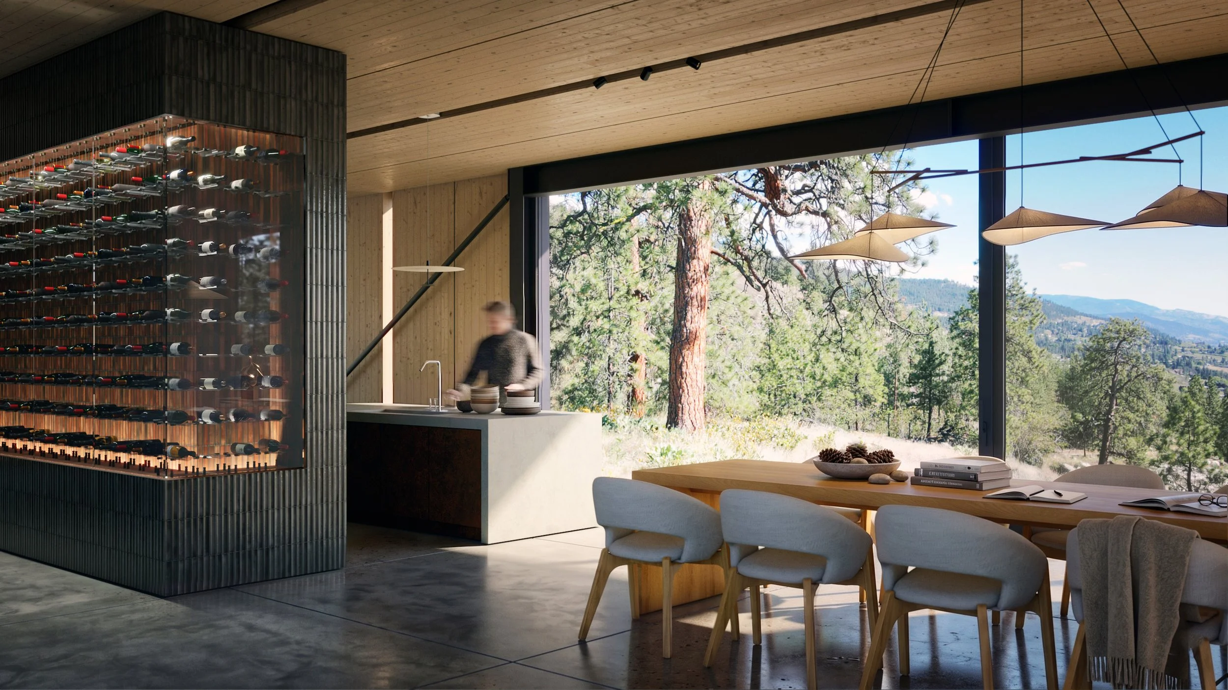 Interior view through the dining room and kitchen toward an existing Ponderosa pine and the rocky hillside beside the house.