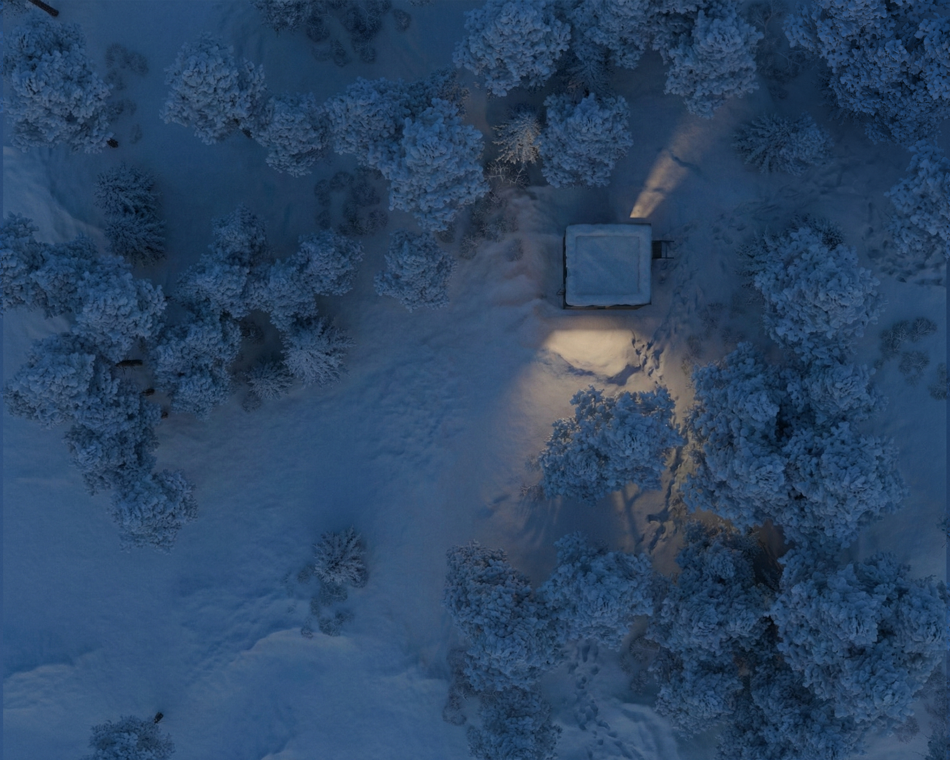 Aerial view of the High Country Shelter set among snow-covered pines in the South Okanagan.