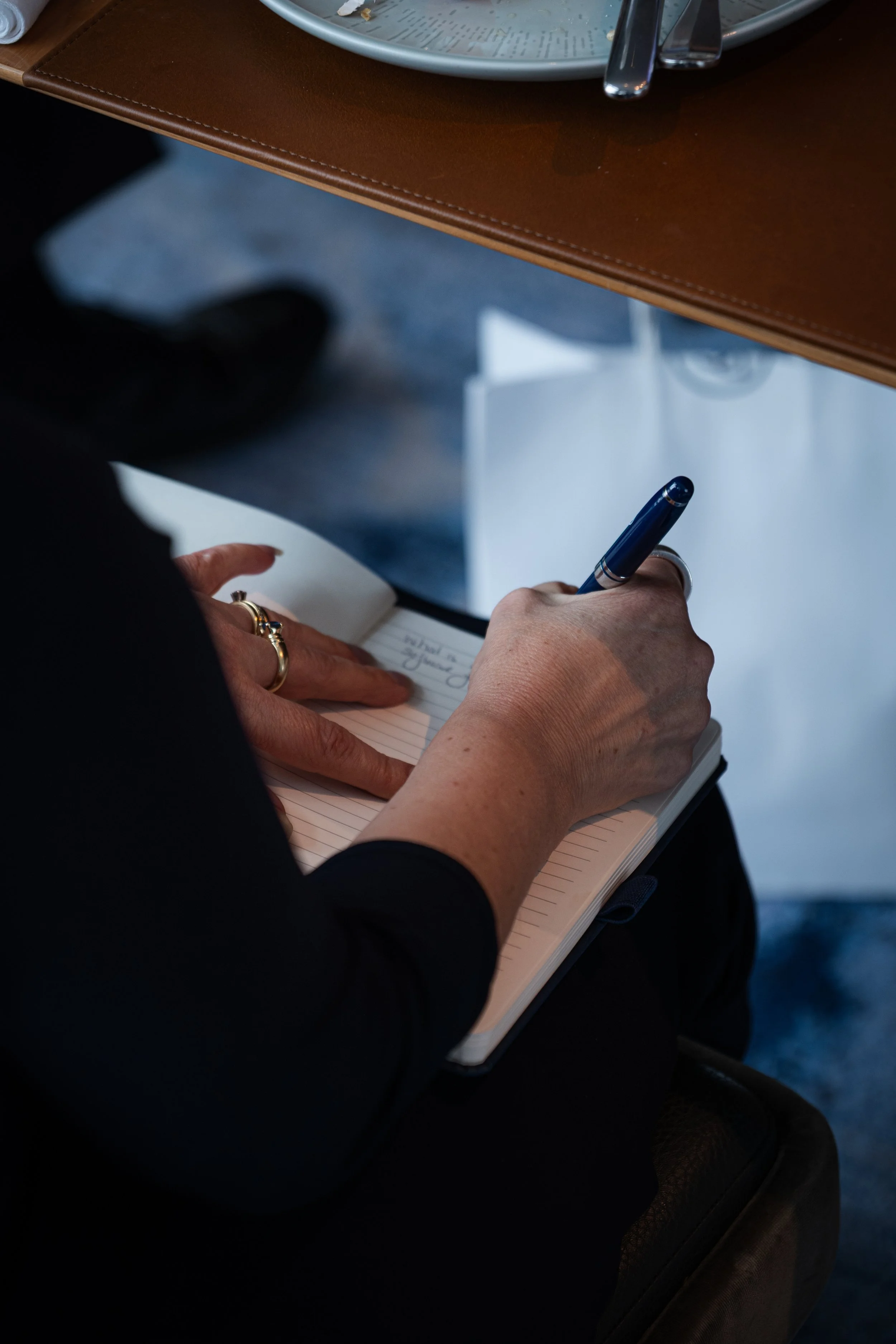 Writing with a pen on a notebook