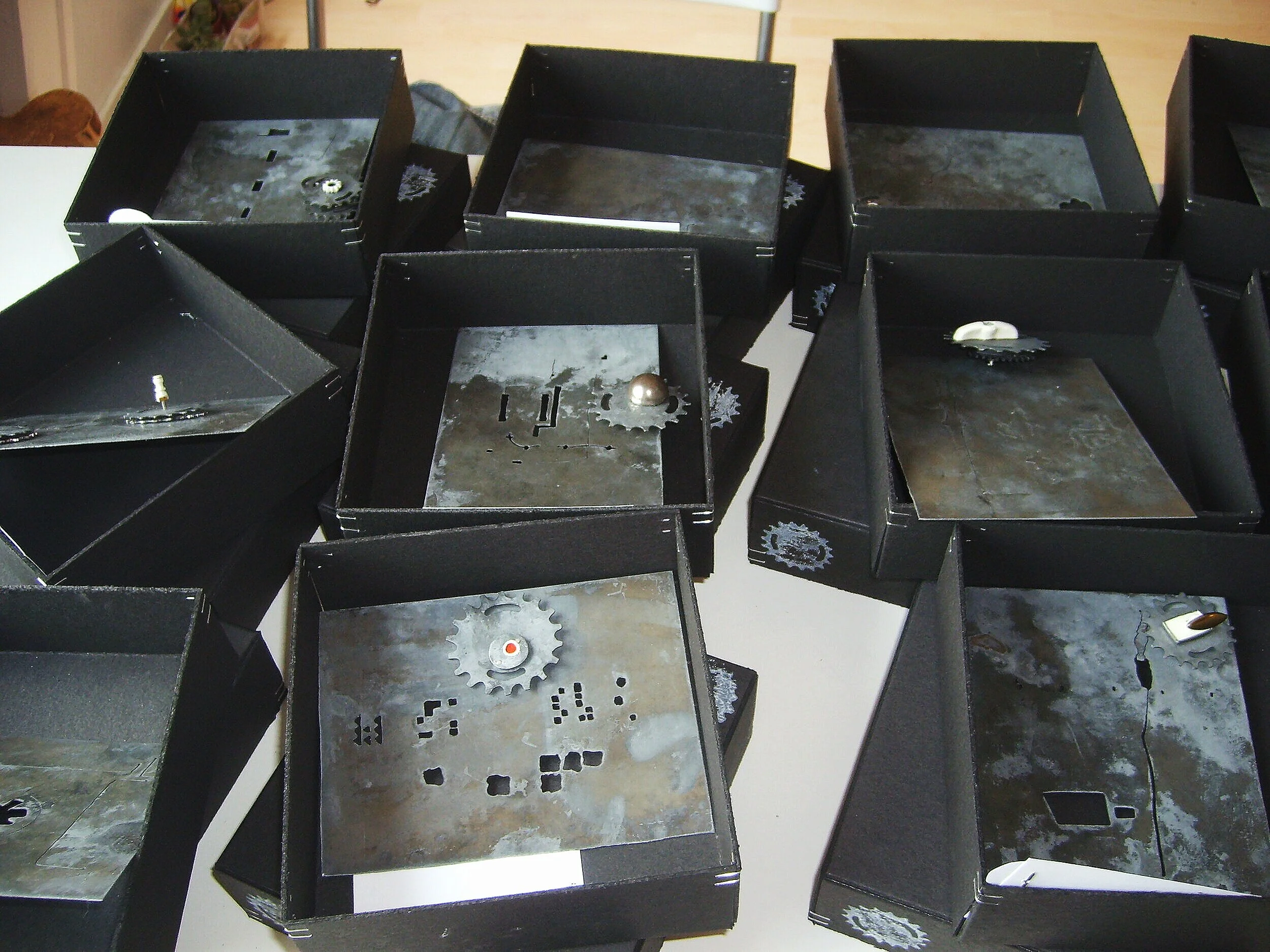 Turn Me On - Materials: Etched zinc, found objects, paint, push pin - All brooches in their boxes, a series of 15 pieces