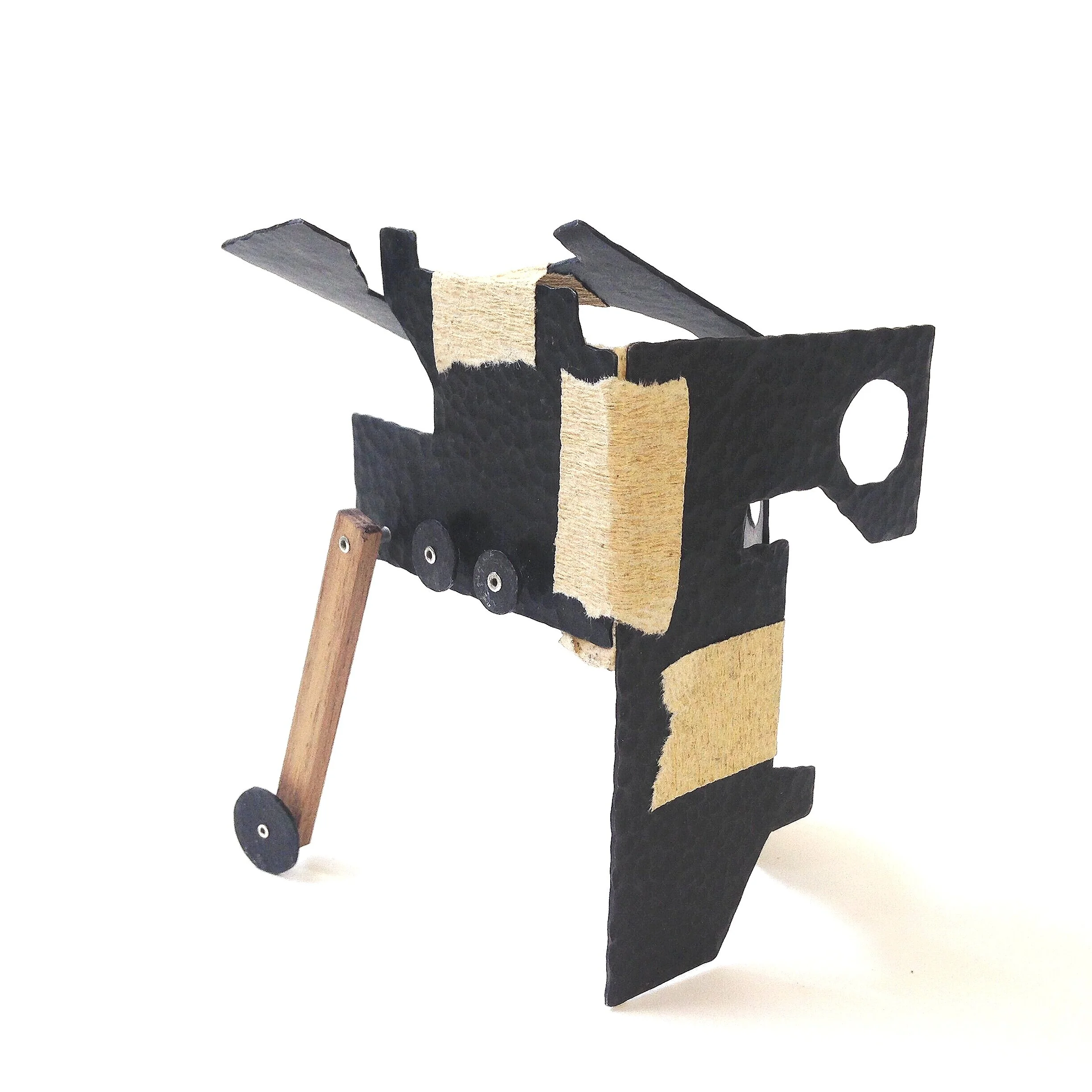 Self Portrait Trilogy 'Nr III.' - Object - Materials: steel, paper tape, silver, wood. 

The paper tape is making sure the 'building blocks' of this piece stay together. The sturdiness and strength of steel in opposite with the temporariness and weak