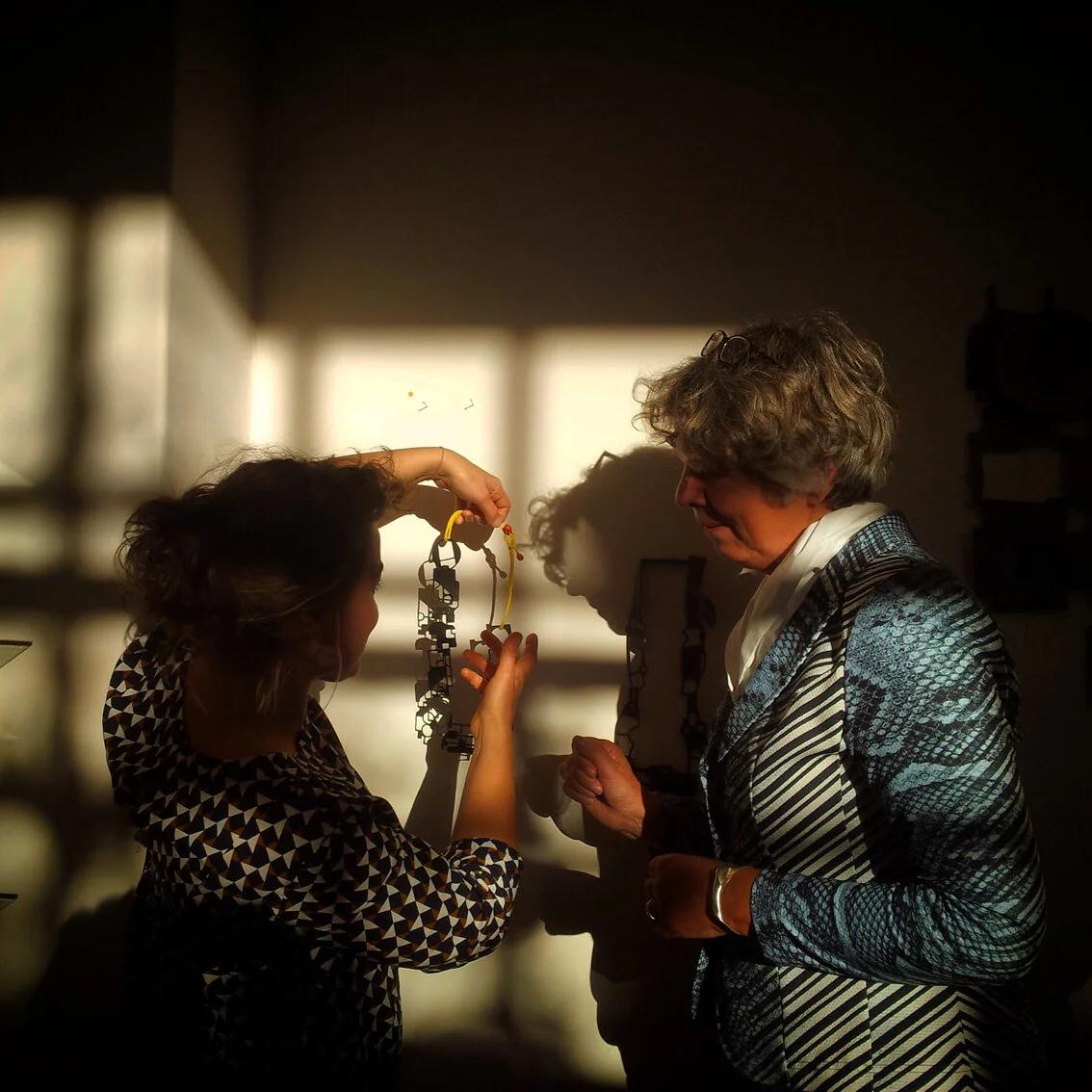 Showing a necklace to its happy owner