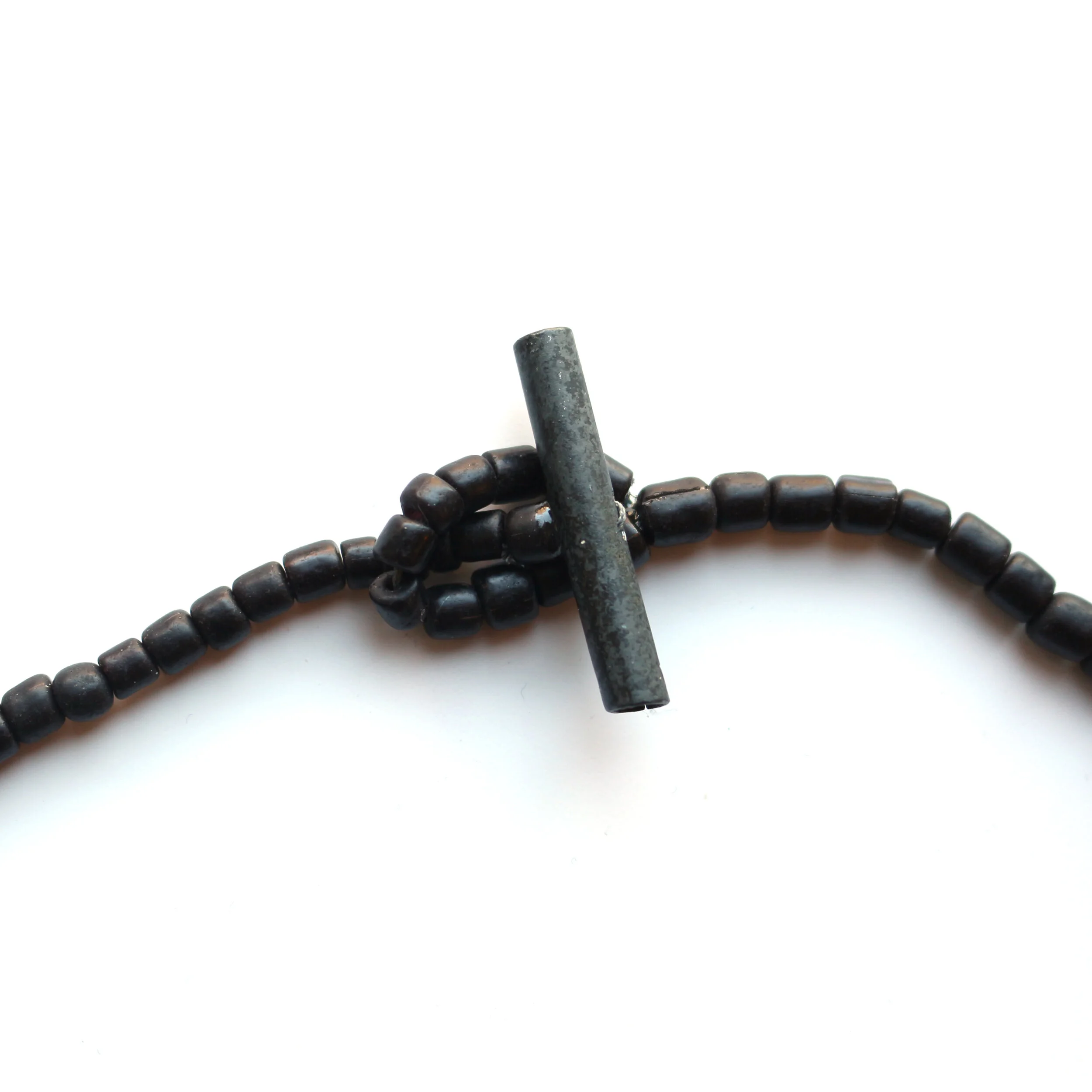 Hug II. /closer/ - Materials: zinc, glass beads, nylon cord