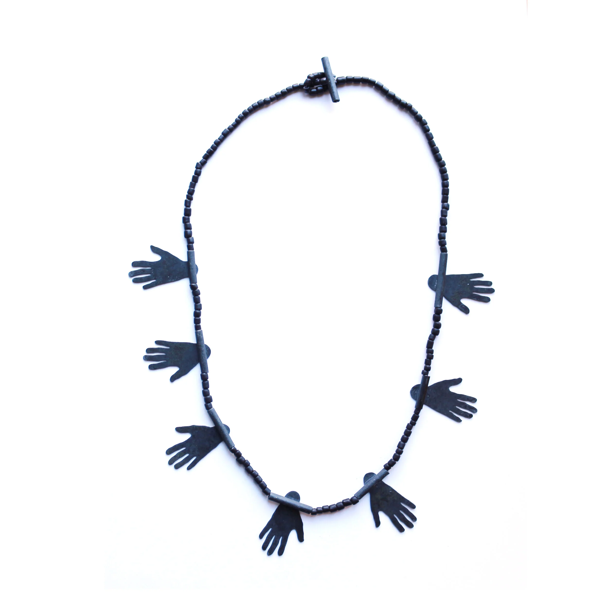 Hug II. - Materials: zinc, glass beads, nylon cord