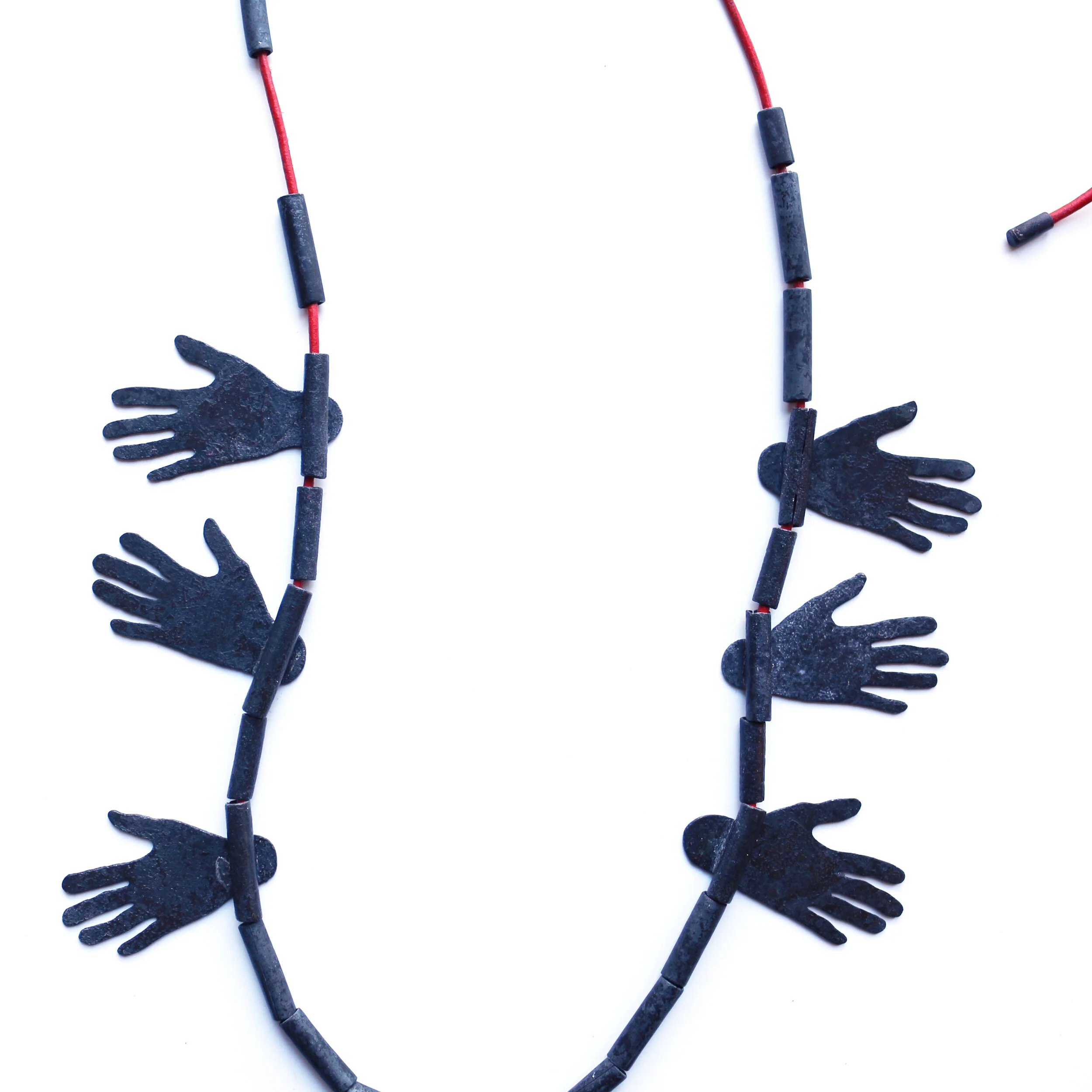 Hug III. /detail/ - Materials: zinc, beads of zinc, leather rope