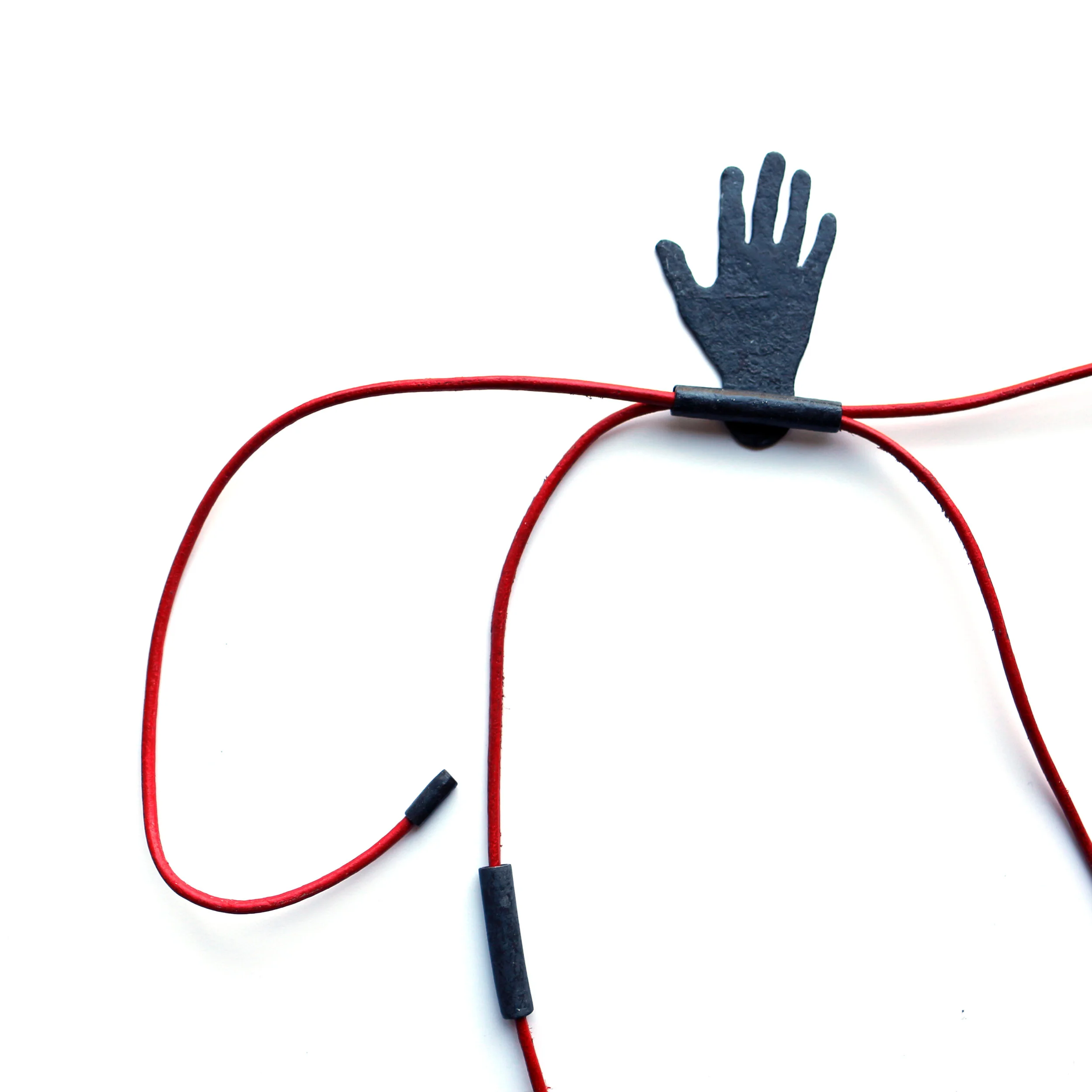 Hug III. /closer/ - Materials: zinc, beads of zinc, leather rope