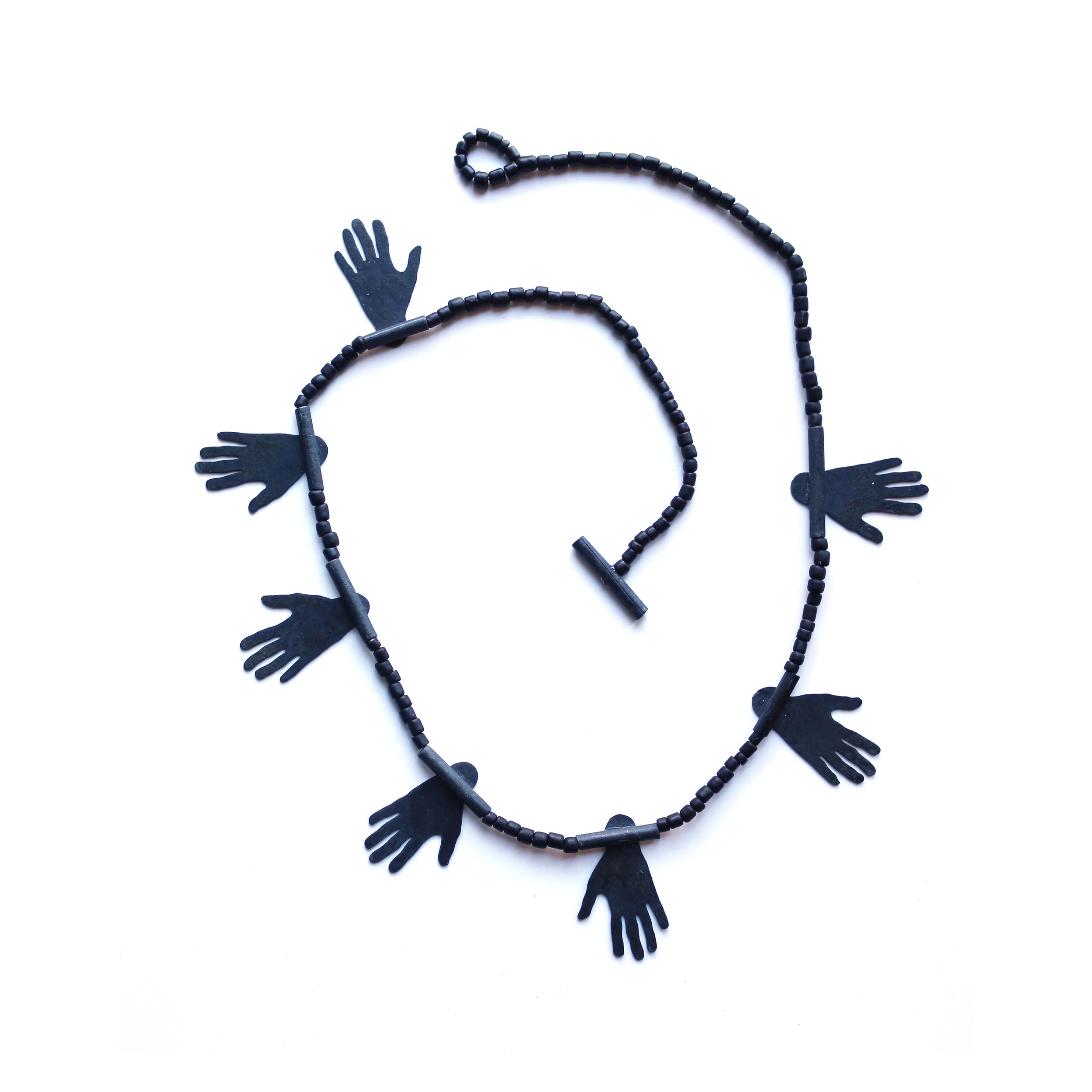 Hug II. - Materials: zinc, glass beads, nylon cord - Collection of CODA Museum, Apeldoorn, NL