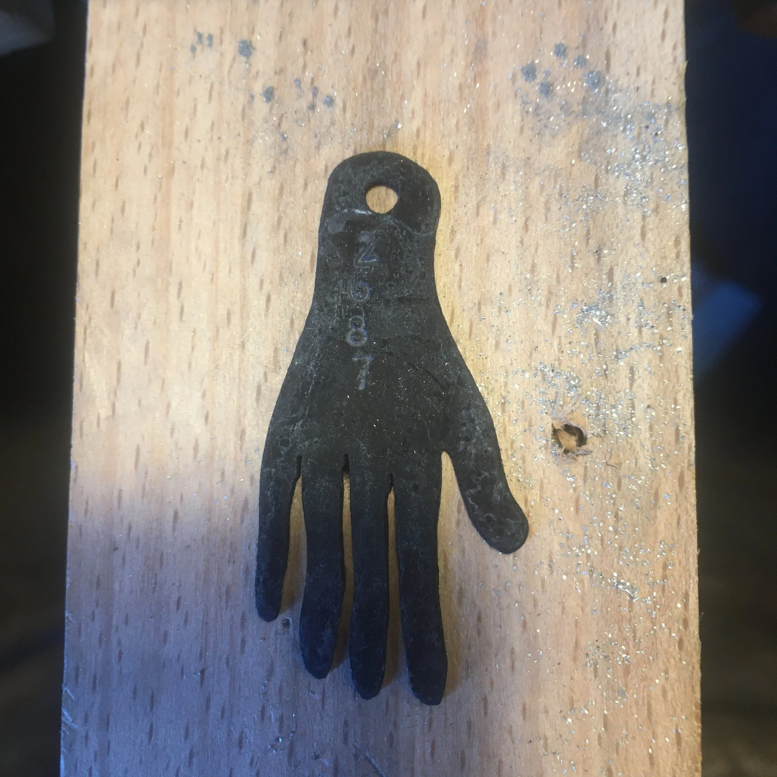 A hand numbered and etched.
