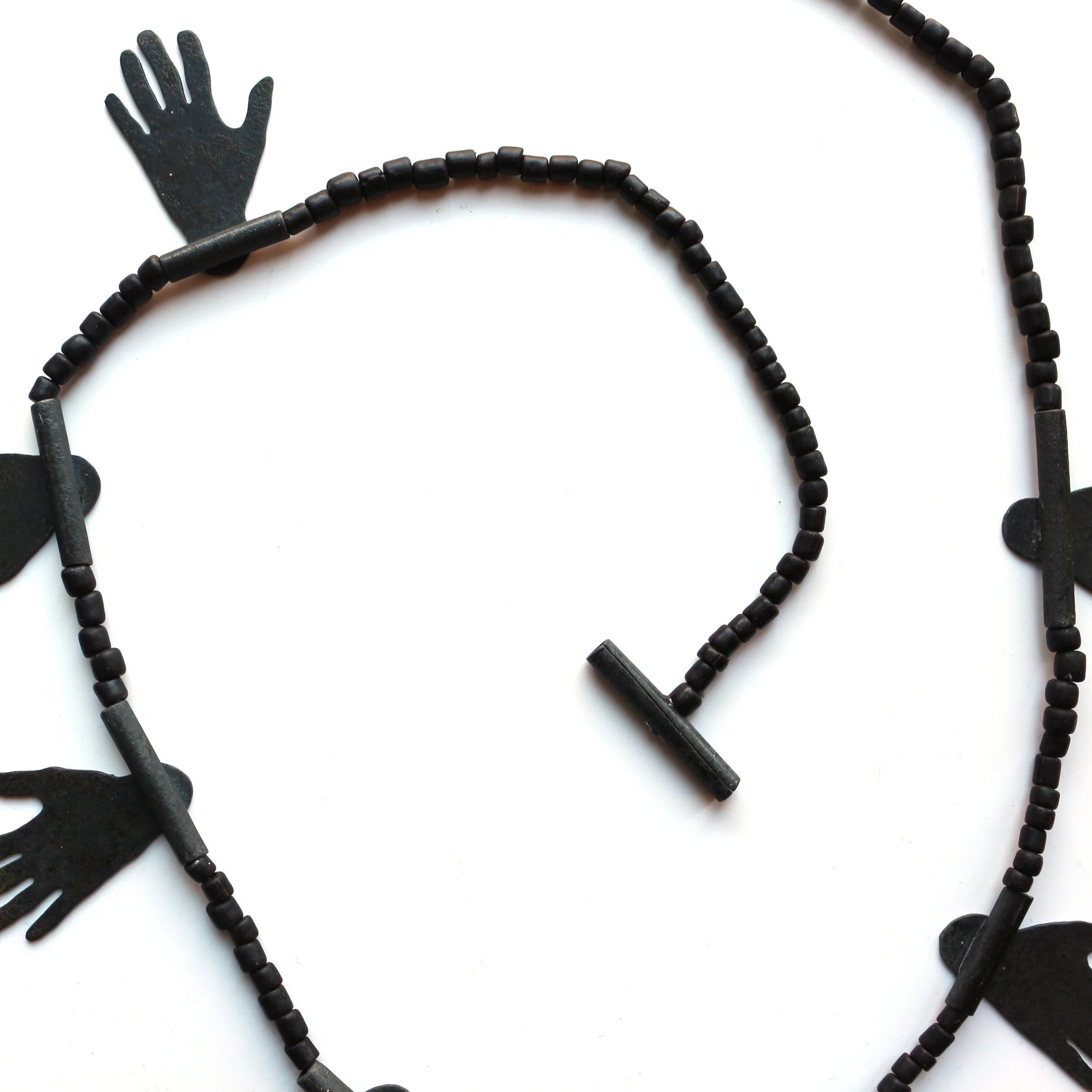 Hug II. /detail/ - Materials: zinc, glass beads, nylon cord