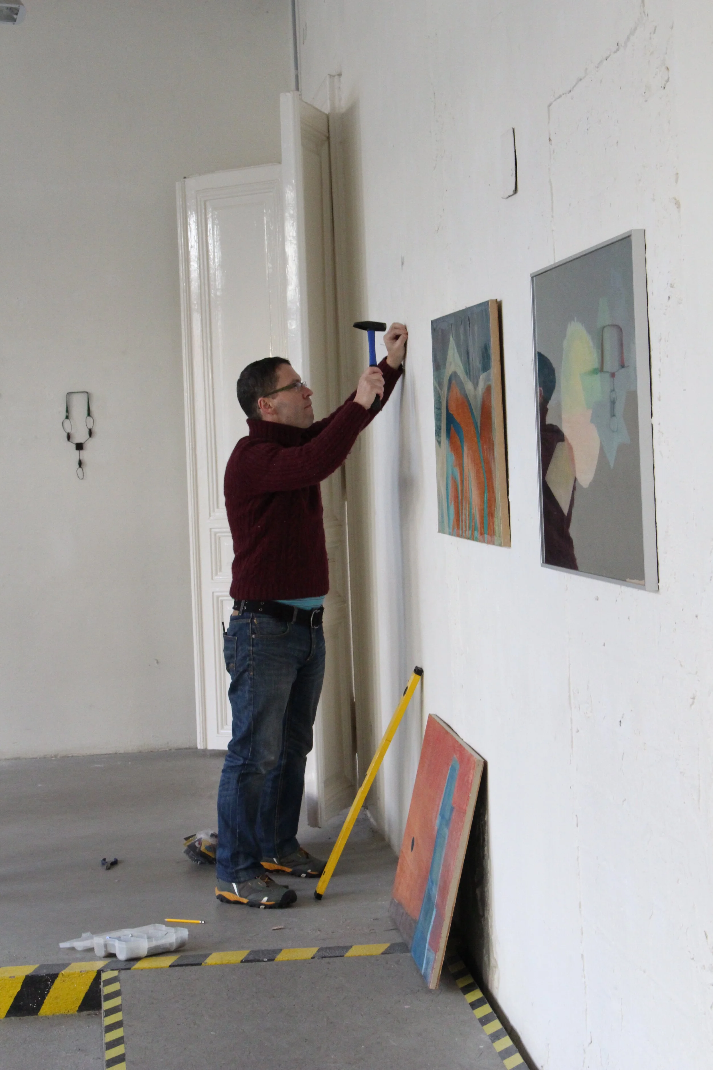 Laci installing the paintings of my grandfather