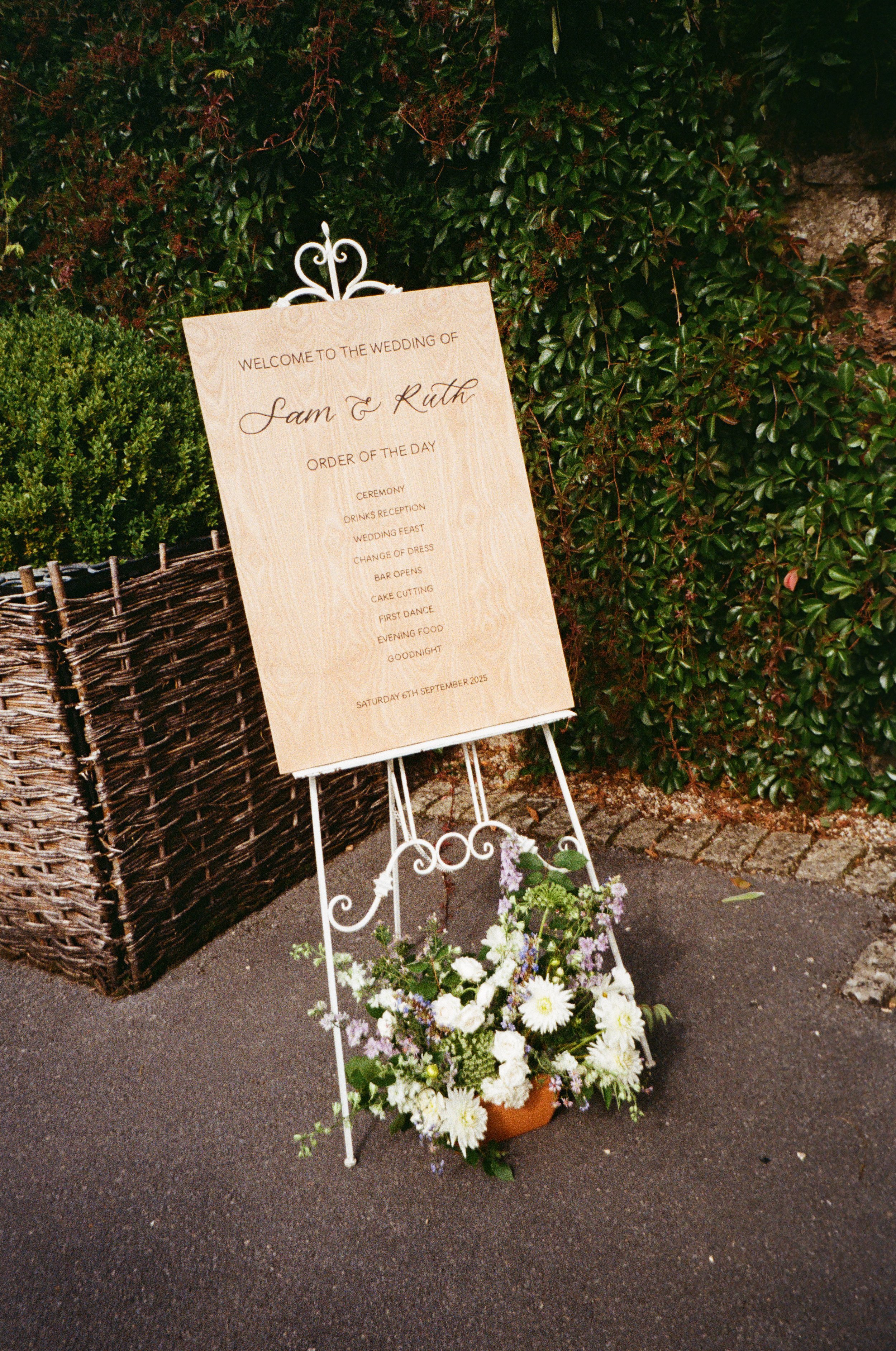 wooden wedding welcome sign with order of the day