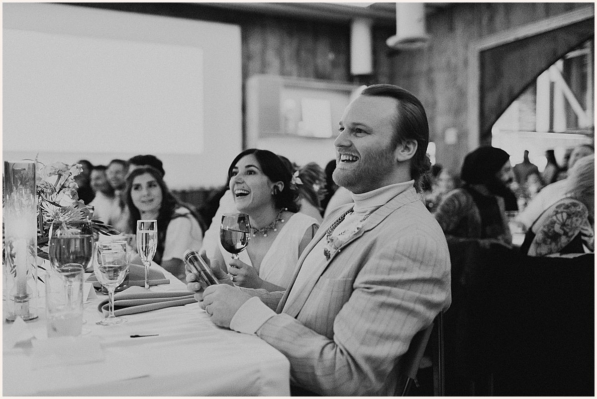 Black and white photo of couple laughing during wedding reception | Lauren Parr Photography